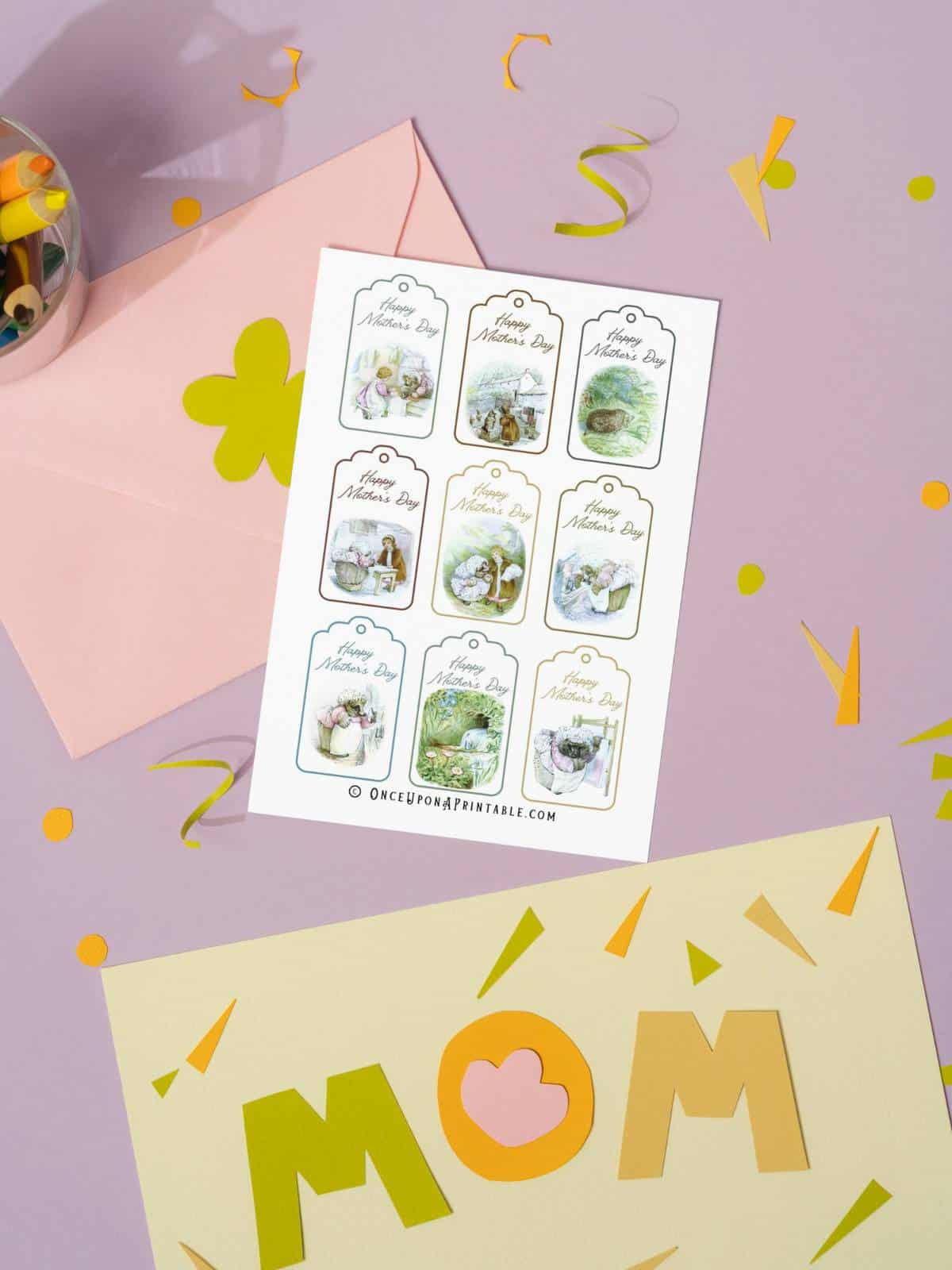 A sheet of Mrs. Tiggy-Winkle Mother's Day gift tags next to colored pencils.