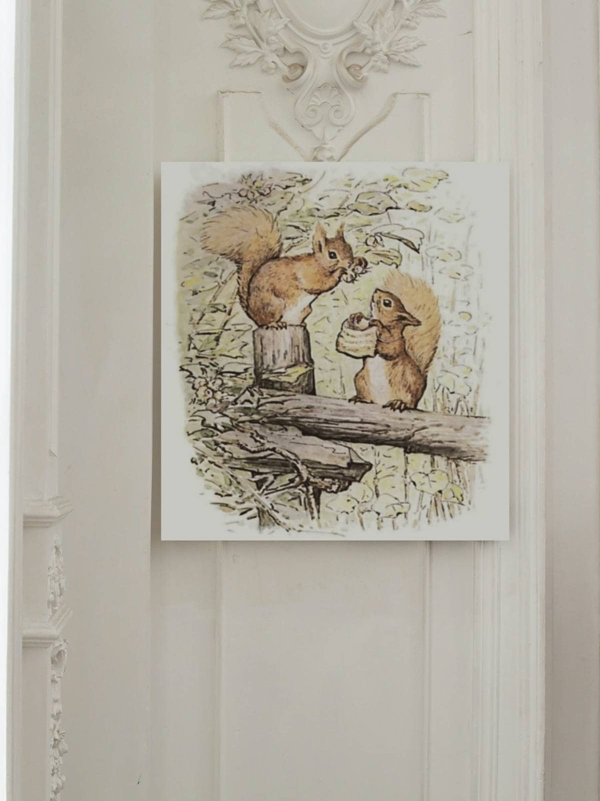 The tale of Squirrel Nutkin by Beatrix Potter framed illustrations as art work on a wall.