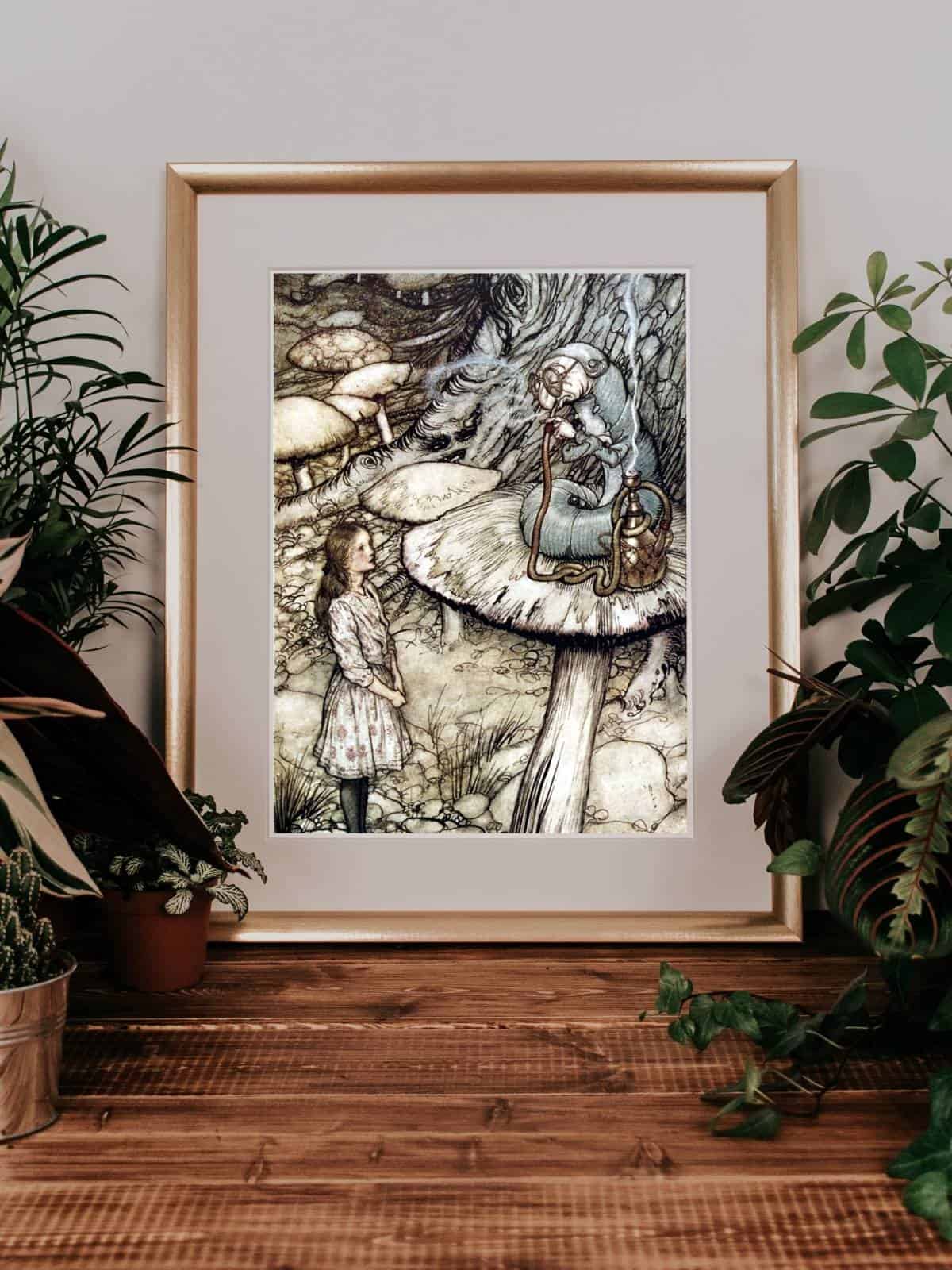 Alice in Wonderland illustrations by Arthur Rackham framed in a gold frame next to plants.