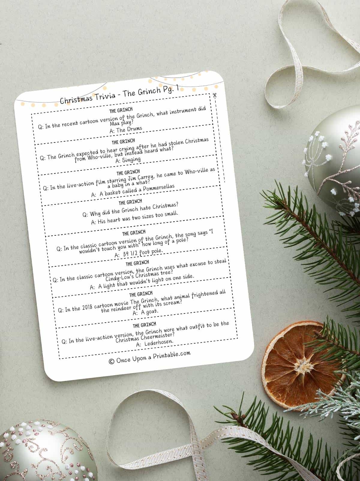 Christmas trivia questions for kids and adults cover photo with a watercolor picture of a family playing games.