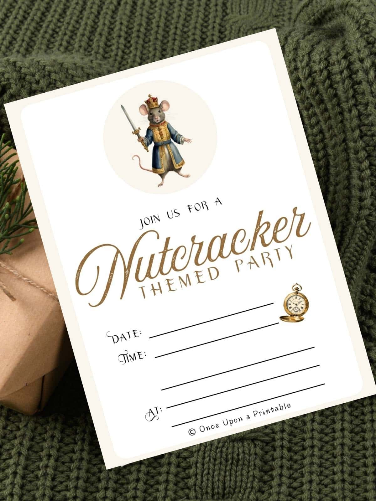 Nutcracker themed party invitation with the Mouse king holding his sword sitting on a green sweater.