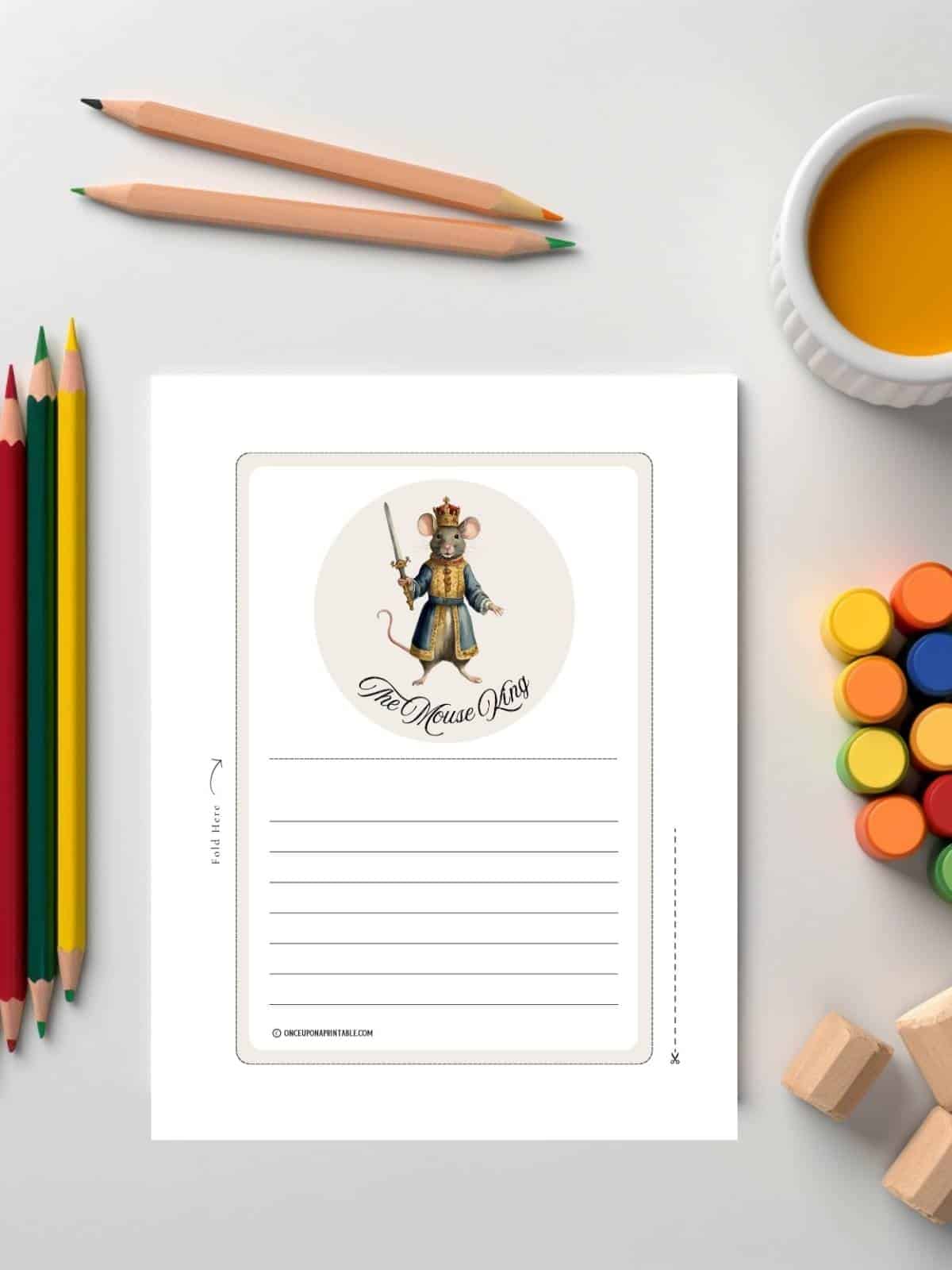 The Mouse King Christmas stationary sitting with colored pencils.