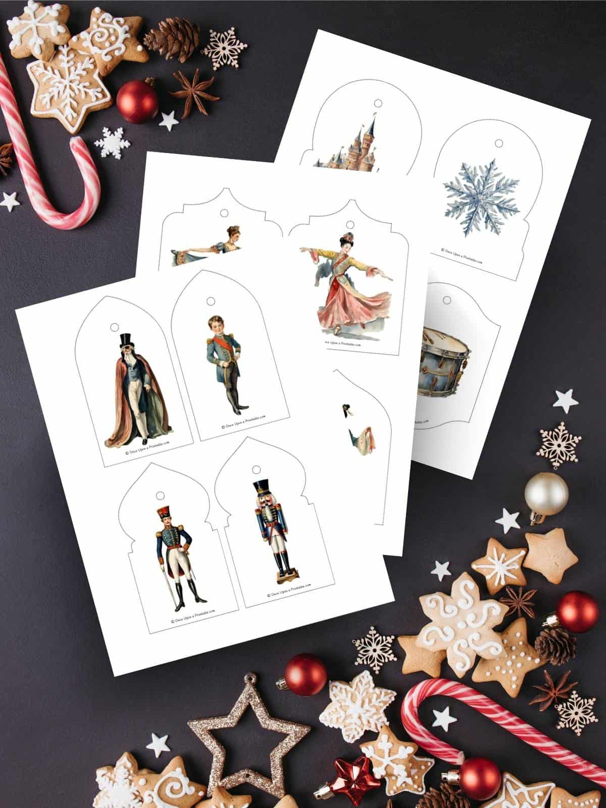 Nutcracker inspired christmas tree ornament printables on a dark blue Christmas themed background with candy and cookies.
