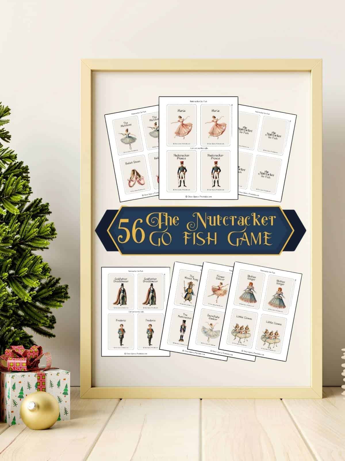 The Nutcracker themed "go fish" game cover page displayed in a frame next to a christmas tree and present.