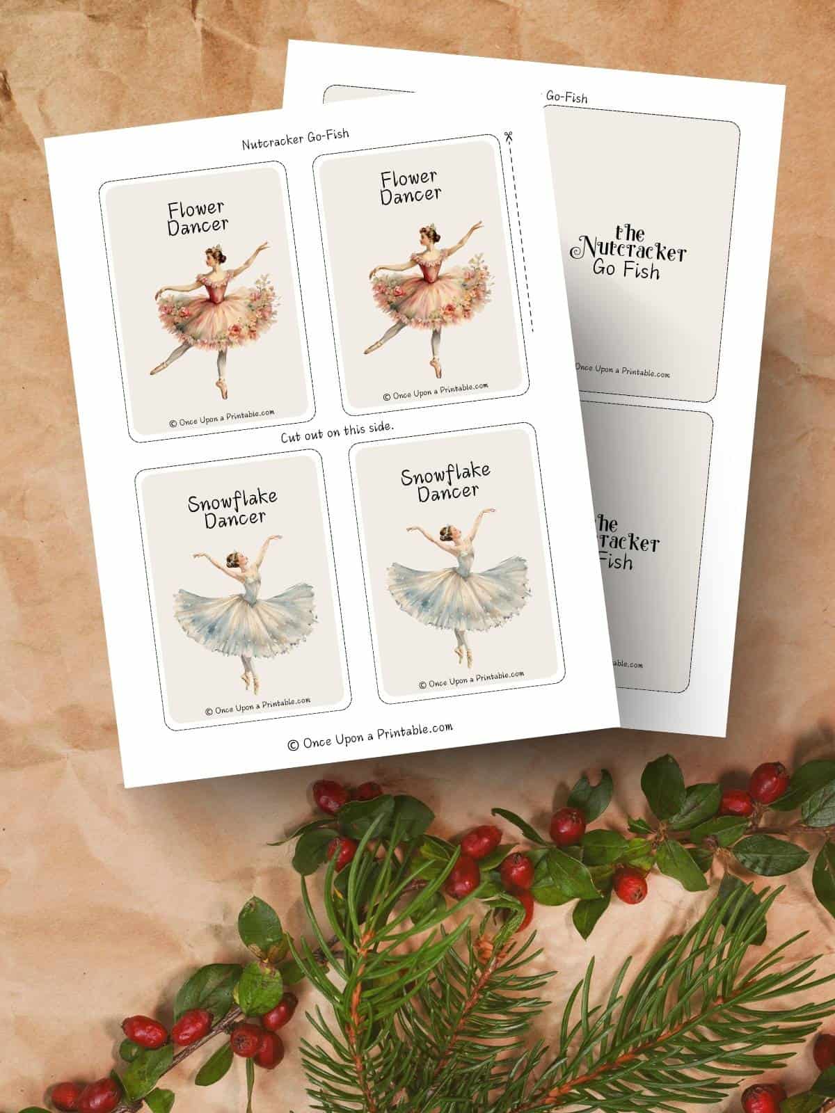 Nutcracker themed 'go fish' cards on a brown paper background with garland and berries.