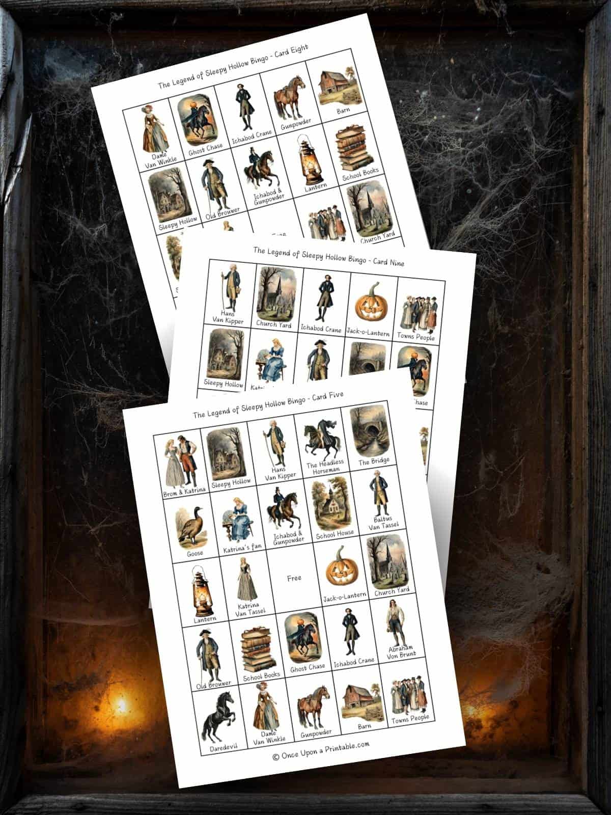 The Legend of Sleepy Hollow Bingo game printables displayed behind a spider's web and lit candles.