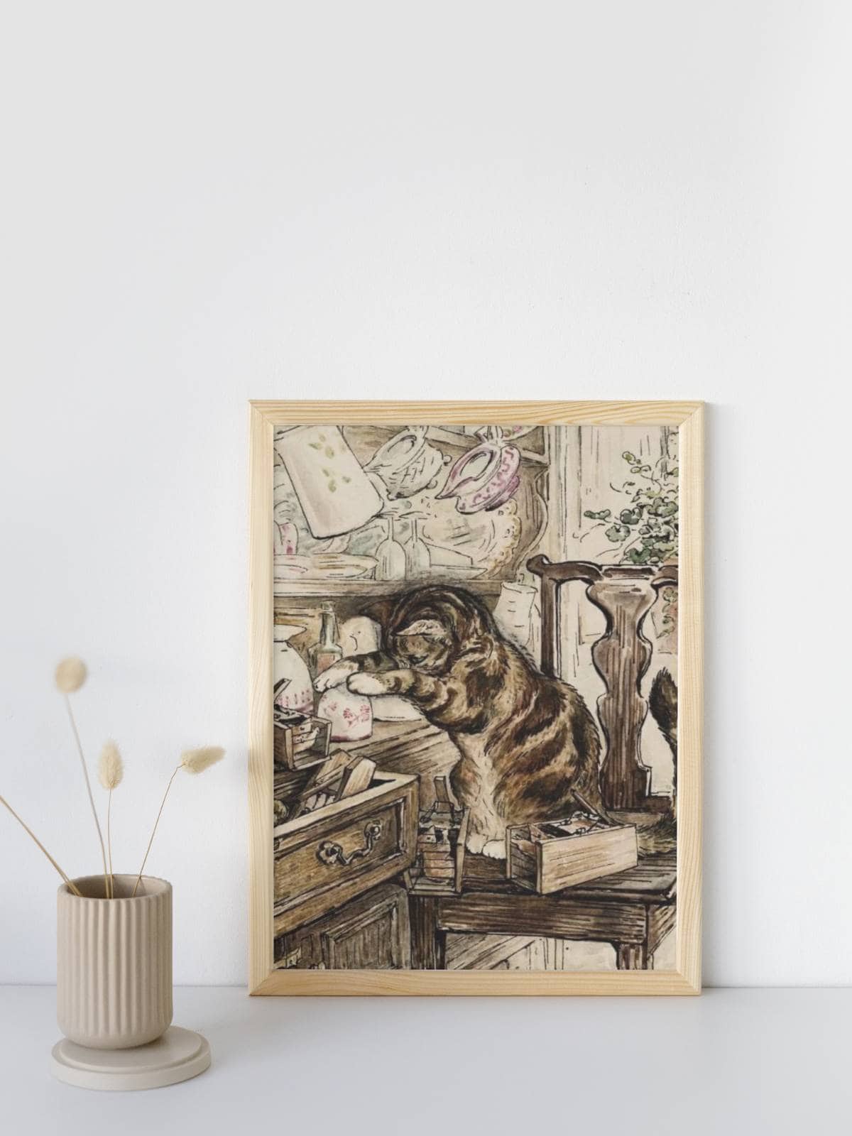 Beatrix potter illustration of a little kitty cat catching a mouse friend, from the Tailor of Gloucester.