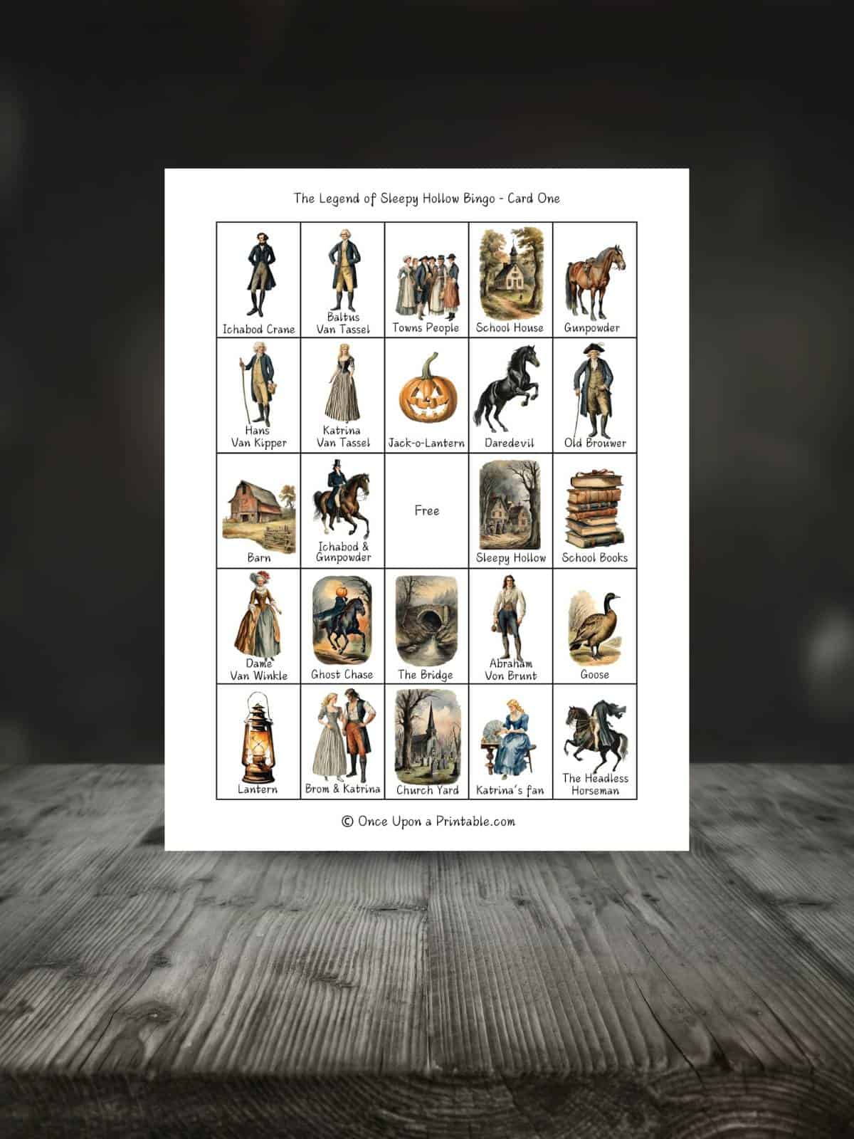 The Legend of Sleepy Hollow Bingo game printables on a wooden table.