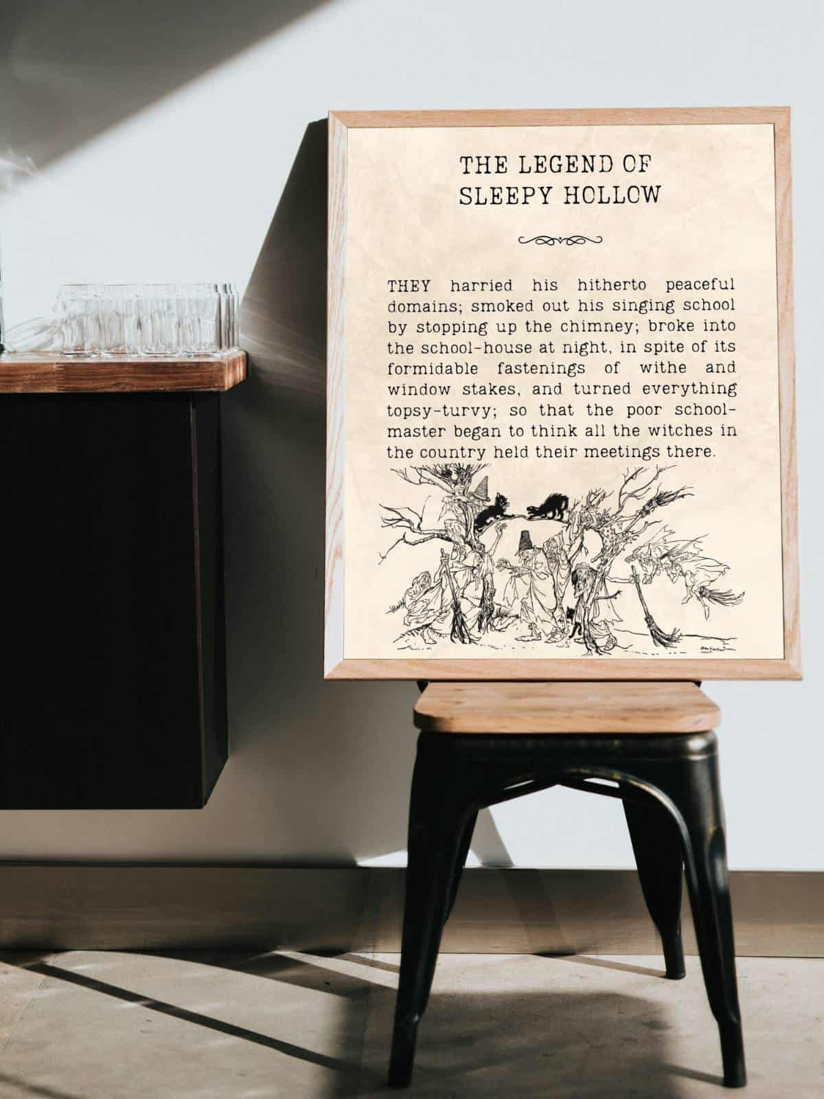 The Legend of Sleepy Hollow quote framed and sitting on top of a stool in a bedroom.