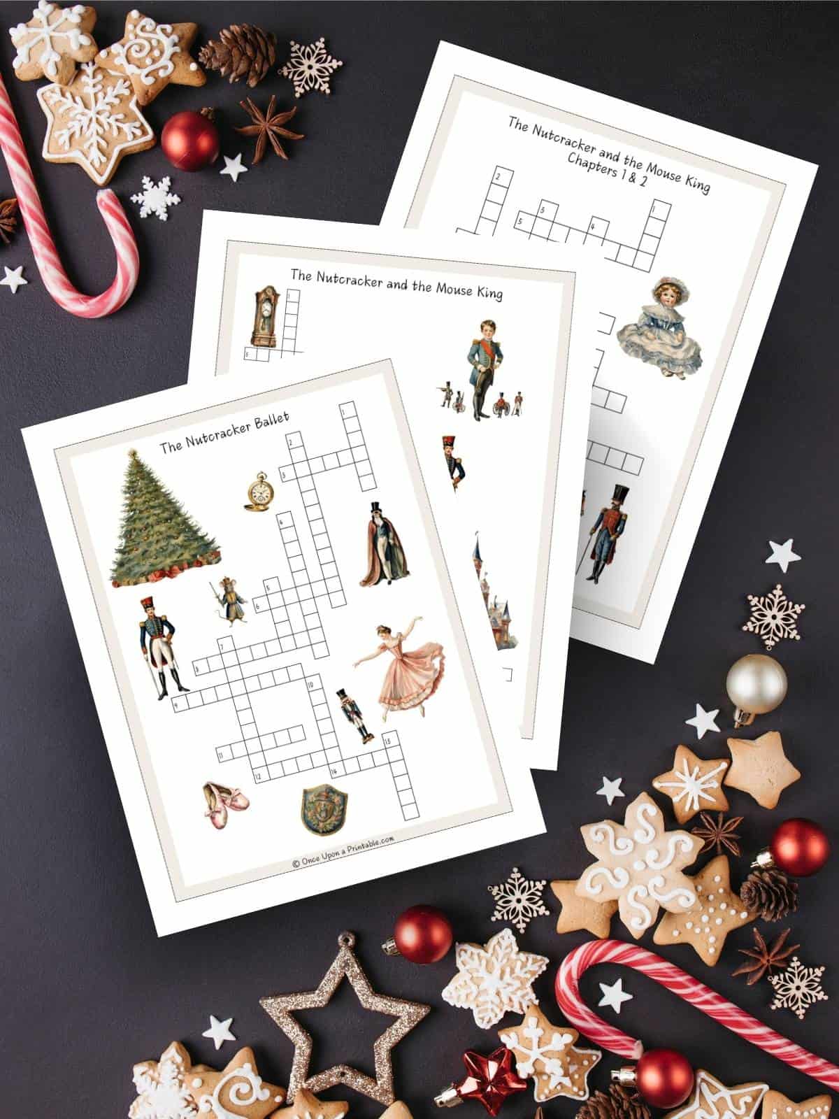 Nutcracker themed crossword puzzles with beautiful vibrant watercolor graphics printed and laying on a dark blue background with candy and cookies.
