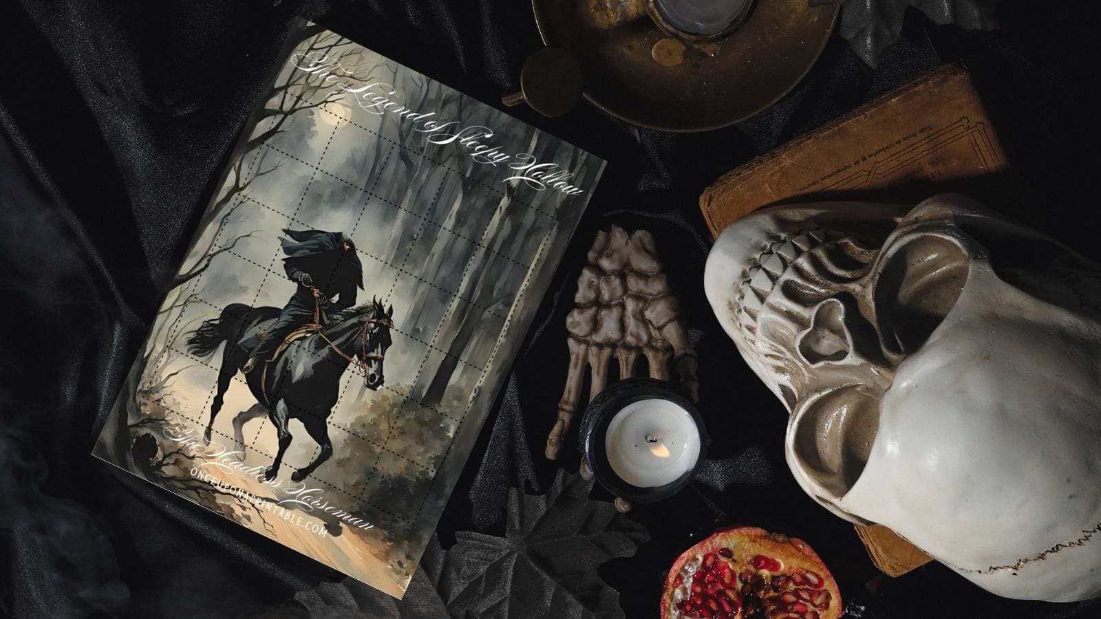 Sleepy Hollow Halloween countdown with the headless horseman printed and laying on a black blanket with plastic skeleton hand and skull, candles, and books. 