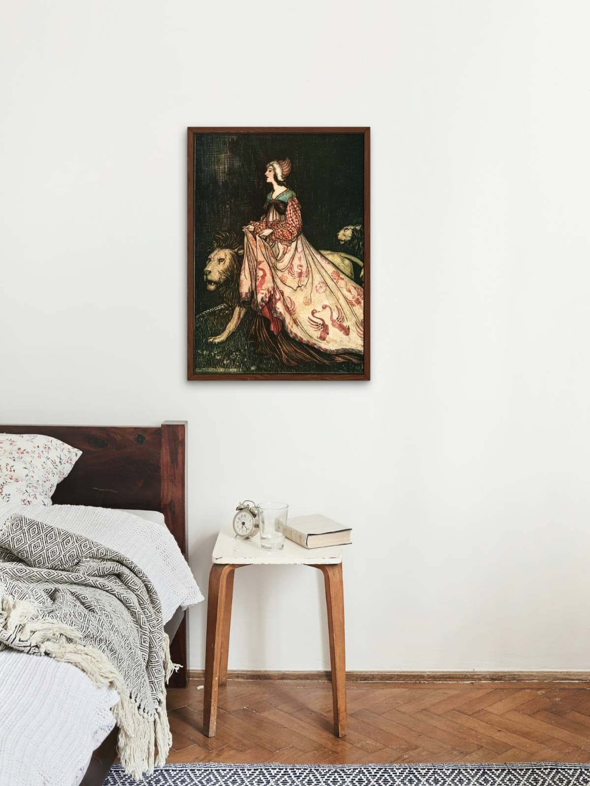 The Brother's Grimm fairy tale "the lady and the lions" illustration framed and displayed above a nightstand near a bed.