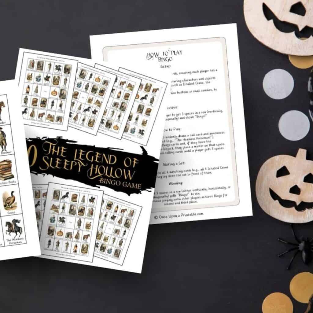 The Legend of Sleepy Hollow Bingo game printables on a black table with jack-o-lanterns and black pumpkins.