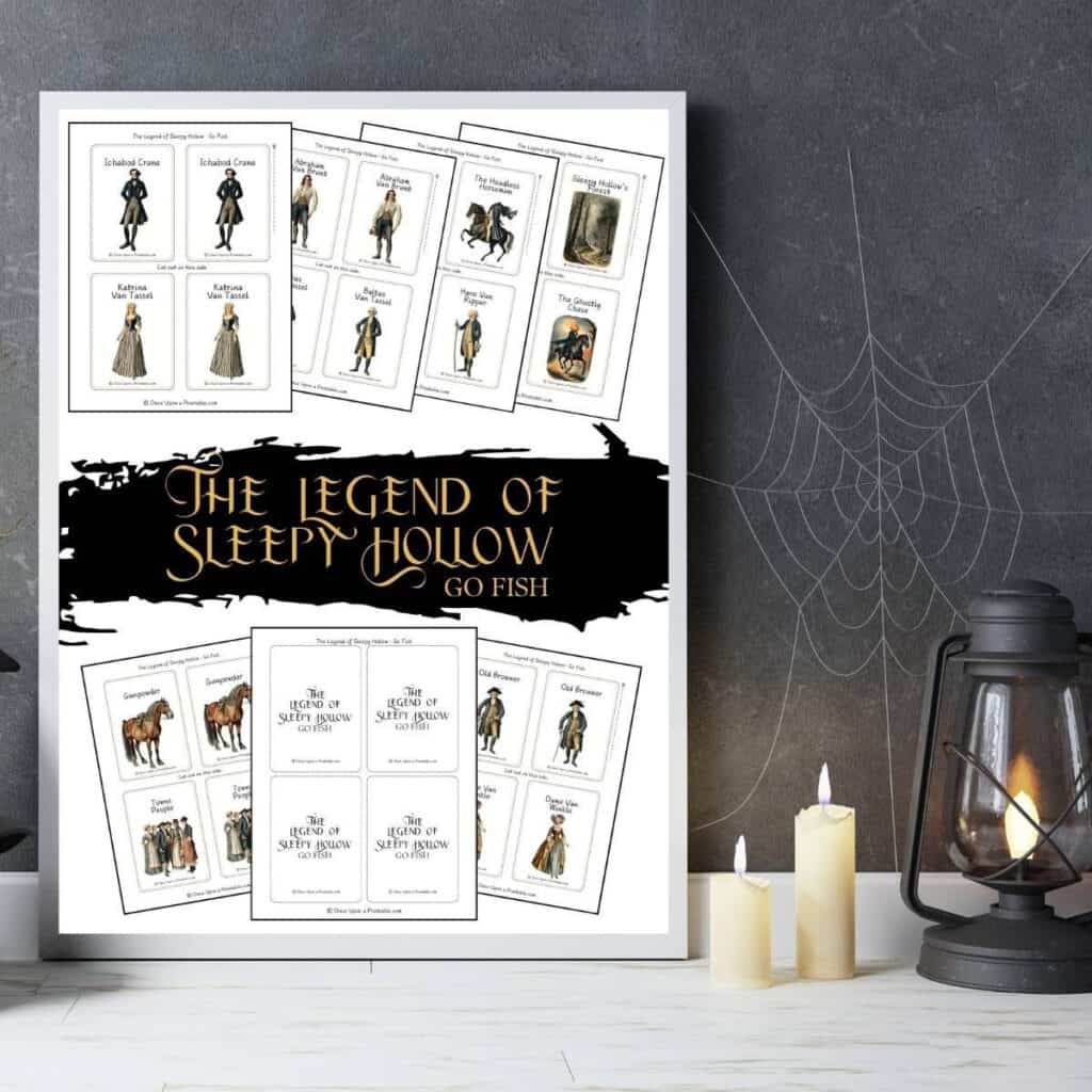 The legend of sleepy hollow go fish game cover page displayed in a frame next to a jack-o-lantern, candles, and a black lantern.