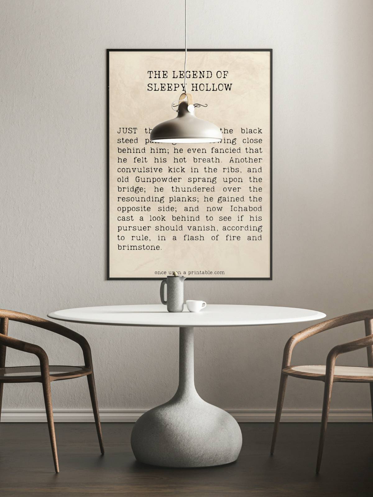 A large framed quote from the legend of sleepy hollow by washington irving displayed above a kitchen table and chairs.