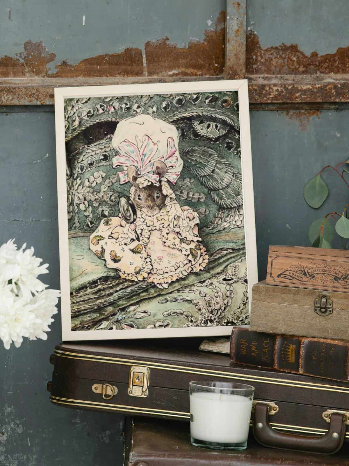 A little girl mouse in a delicate and intricate victorian-style gown framed sitting on a guitar case with books and flowers.