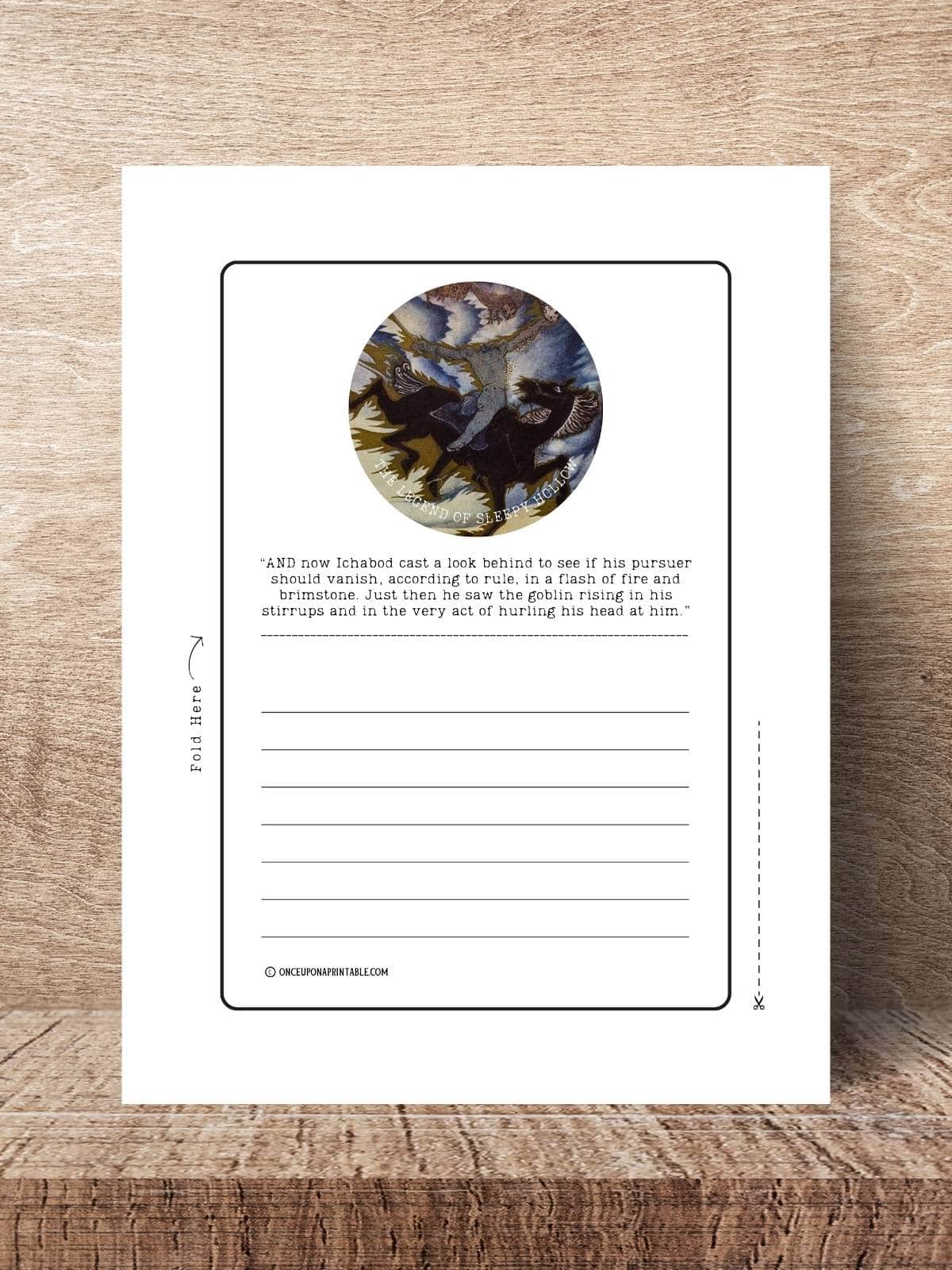 The headless horseman illustration by Arthur Rackham on a stationary page displayed on a wooden table.