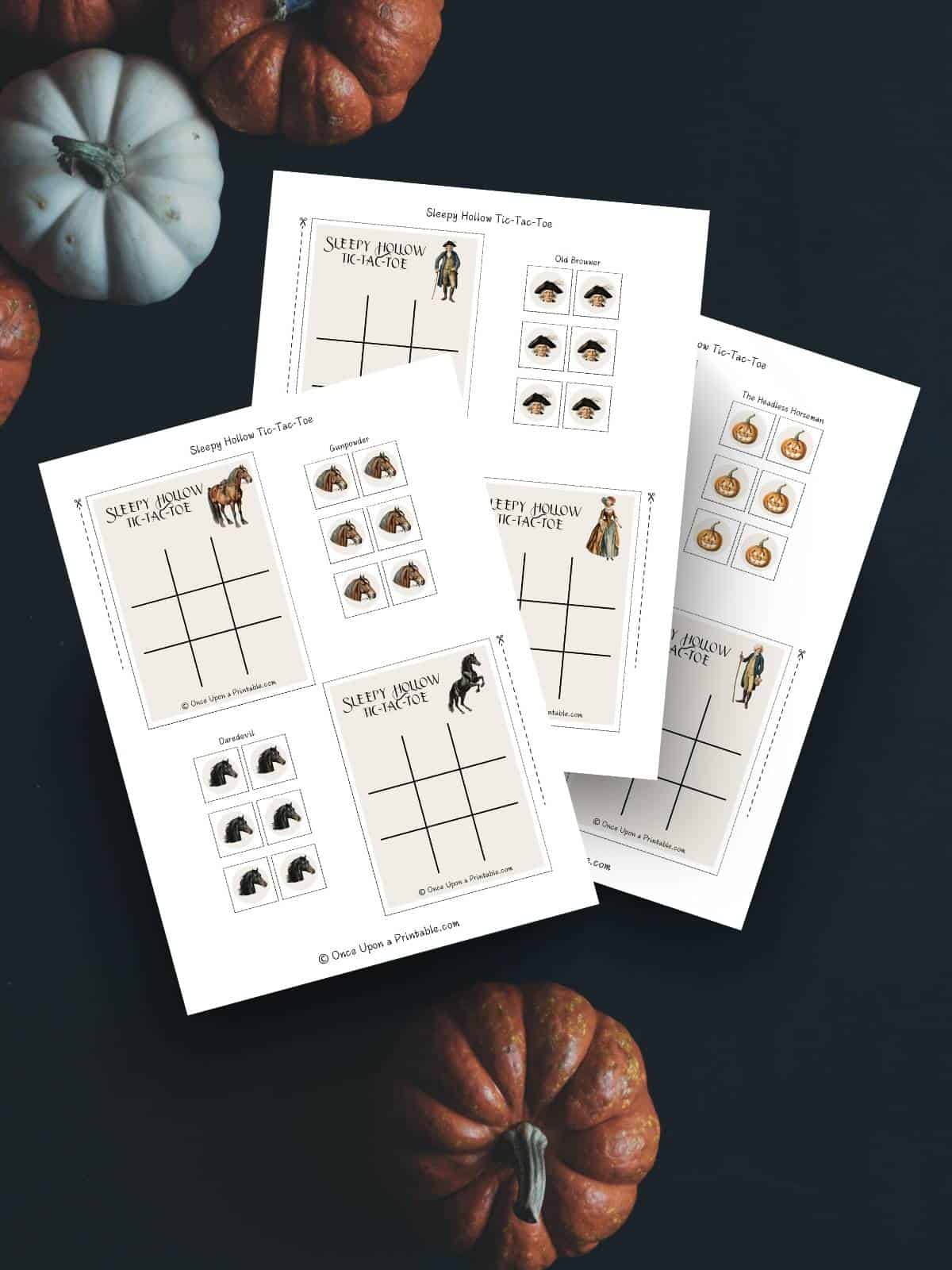 The Legend of Sleepy Hollow tic tac toe game card print outs displayed with pumpkins on a dark black background.