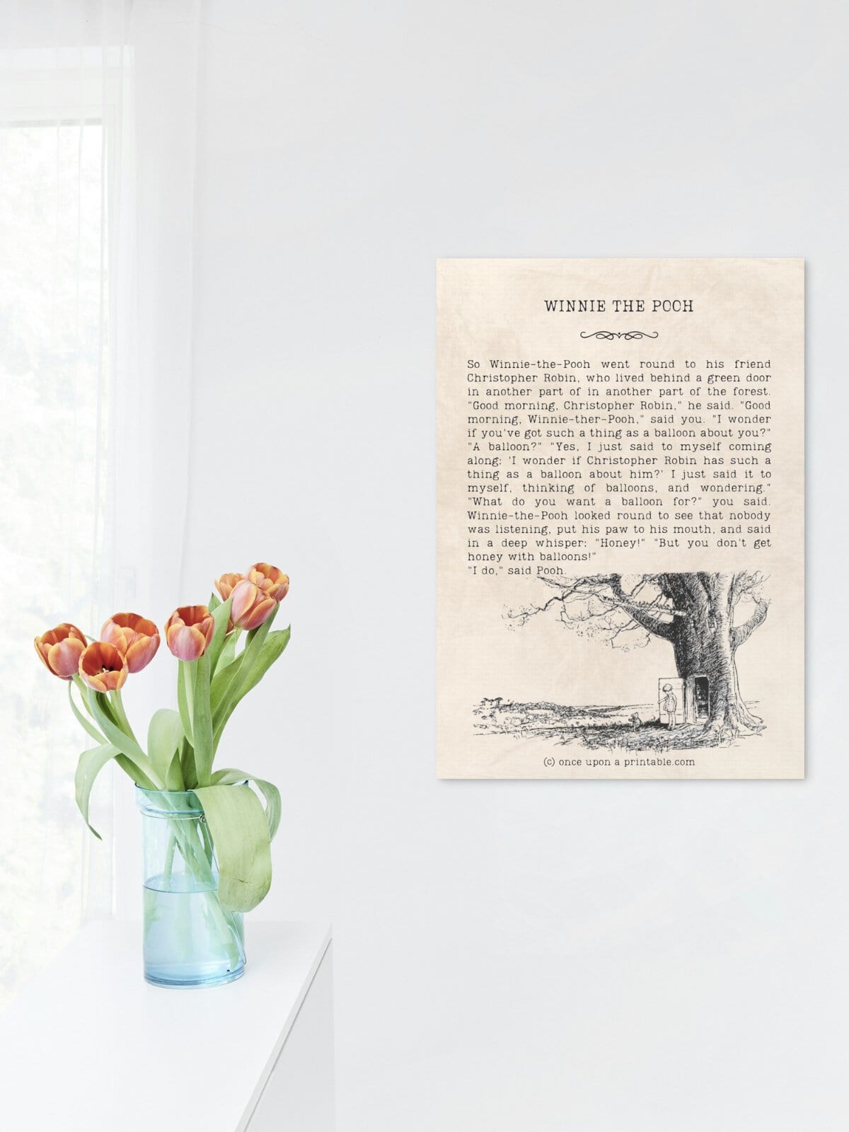 Winnie the Pooh quotes in a frame with original illustrations by E. H. Shepard, displayed by a vase of brightly coral colored tulips.