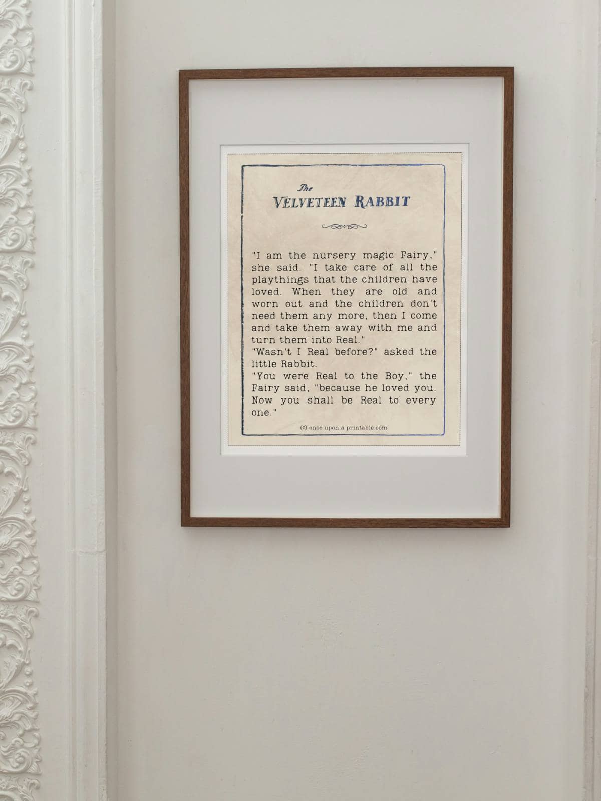 Framed and displayed quote from the book the velveteen rabbit hanging on a wall.