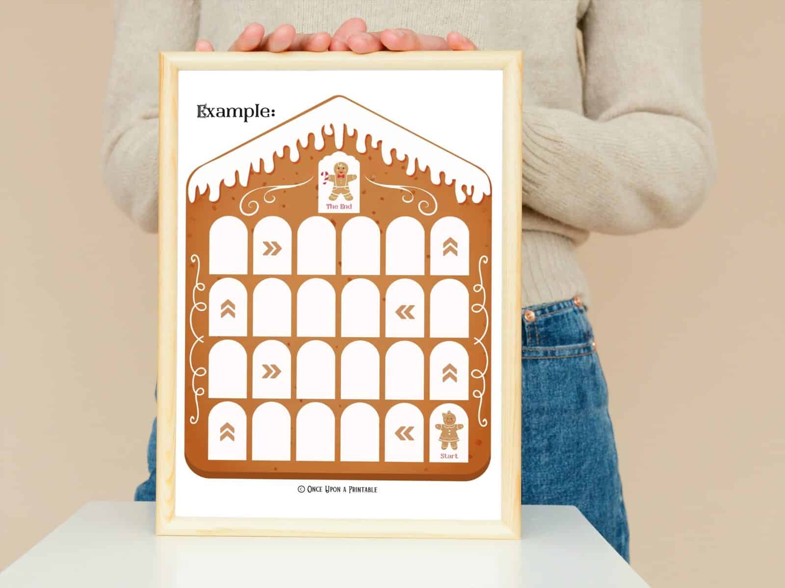 Gingerbread house countdown calendar game board example framed and held by a woman.