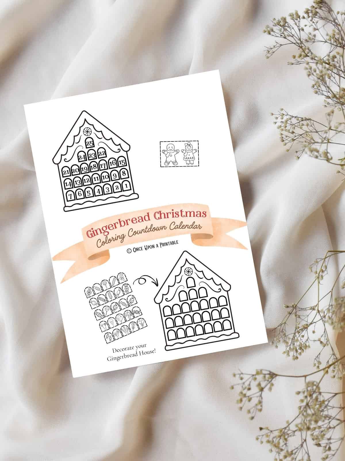 Gingerbread Coloring countdown calendar cover page sitting on a white tablecloth and baby's breath flowers.