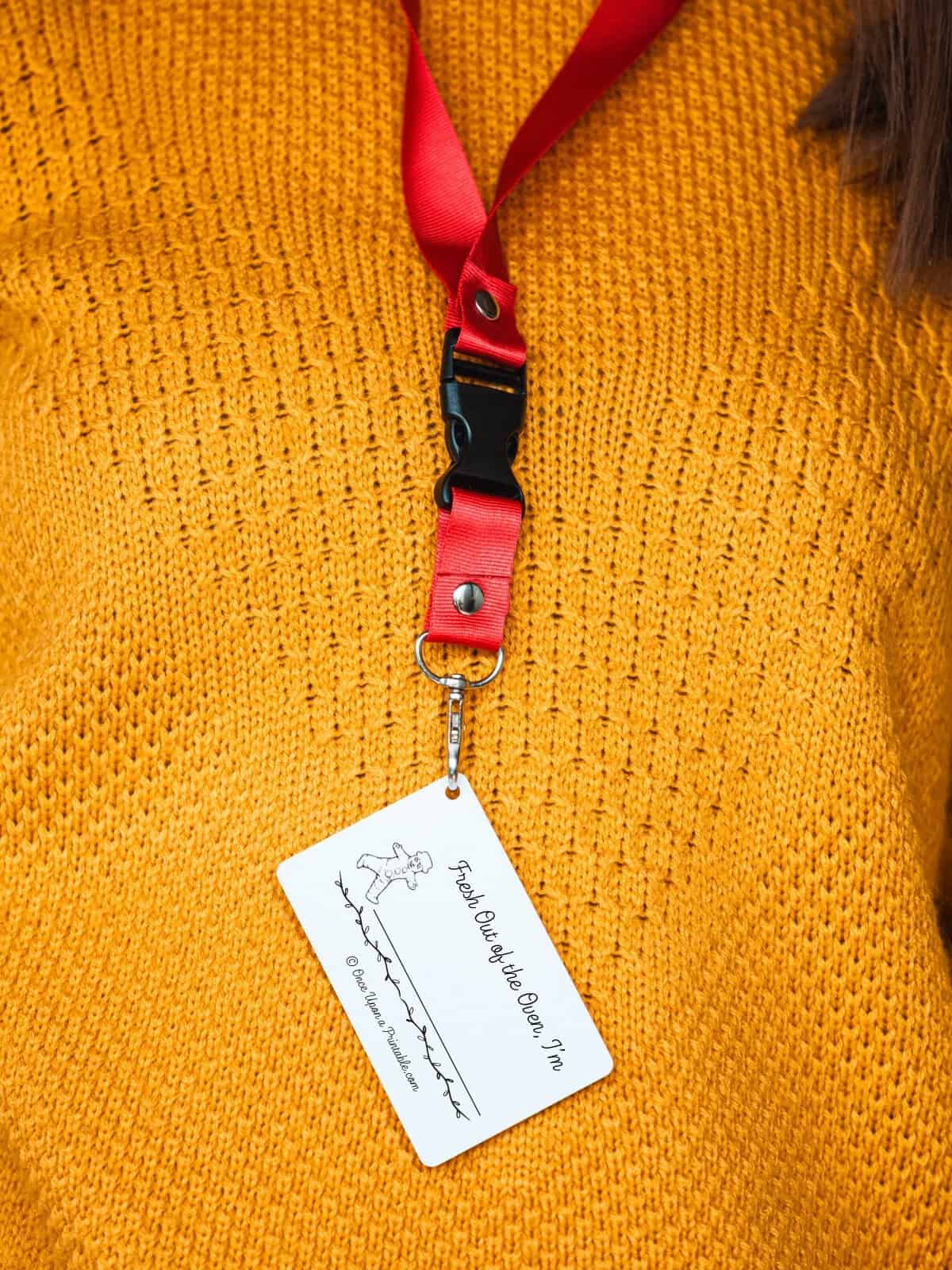 Gingerbread illustrated name tag on a lanyard around a woman's neck.