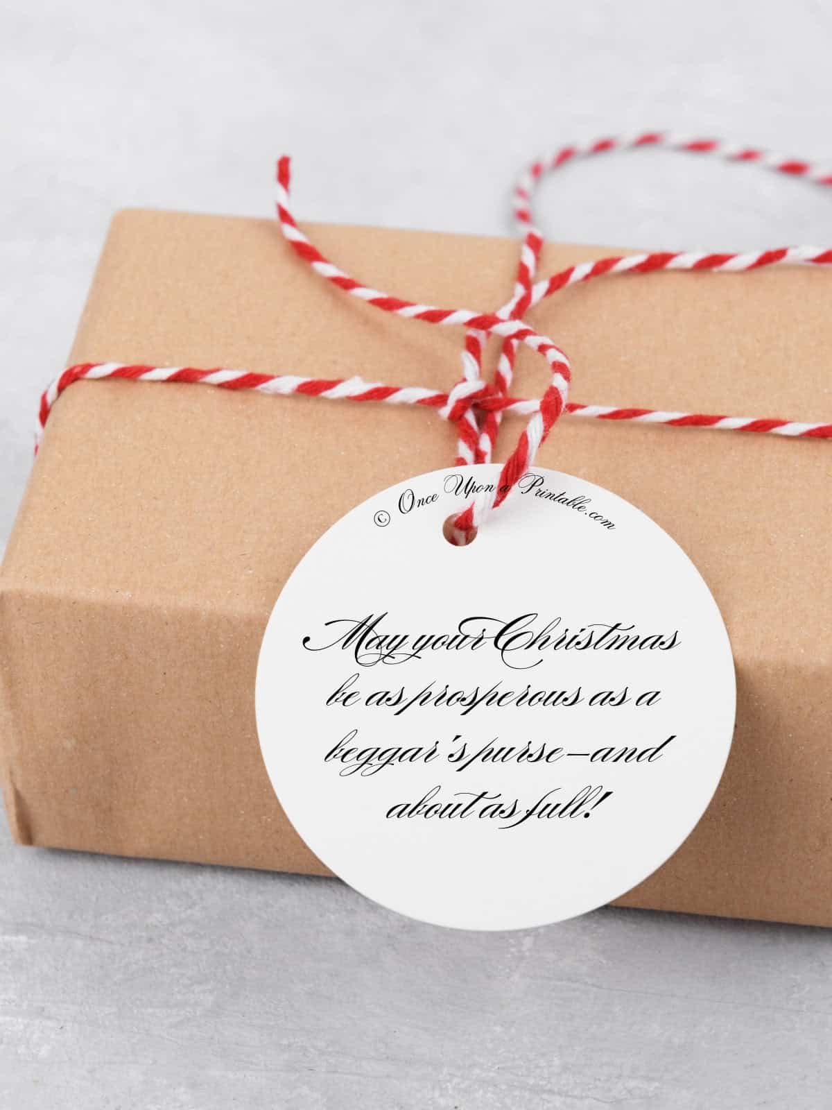 Grouchy christmas gift tag on a brown paper wrapped christmas present.