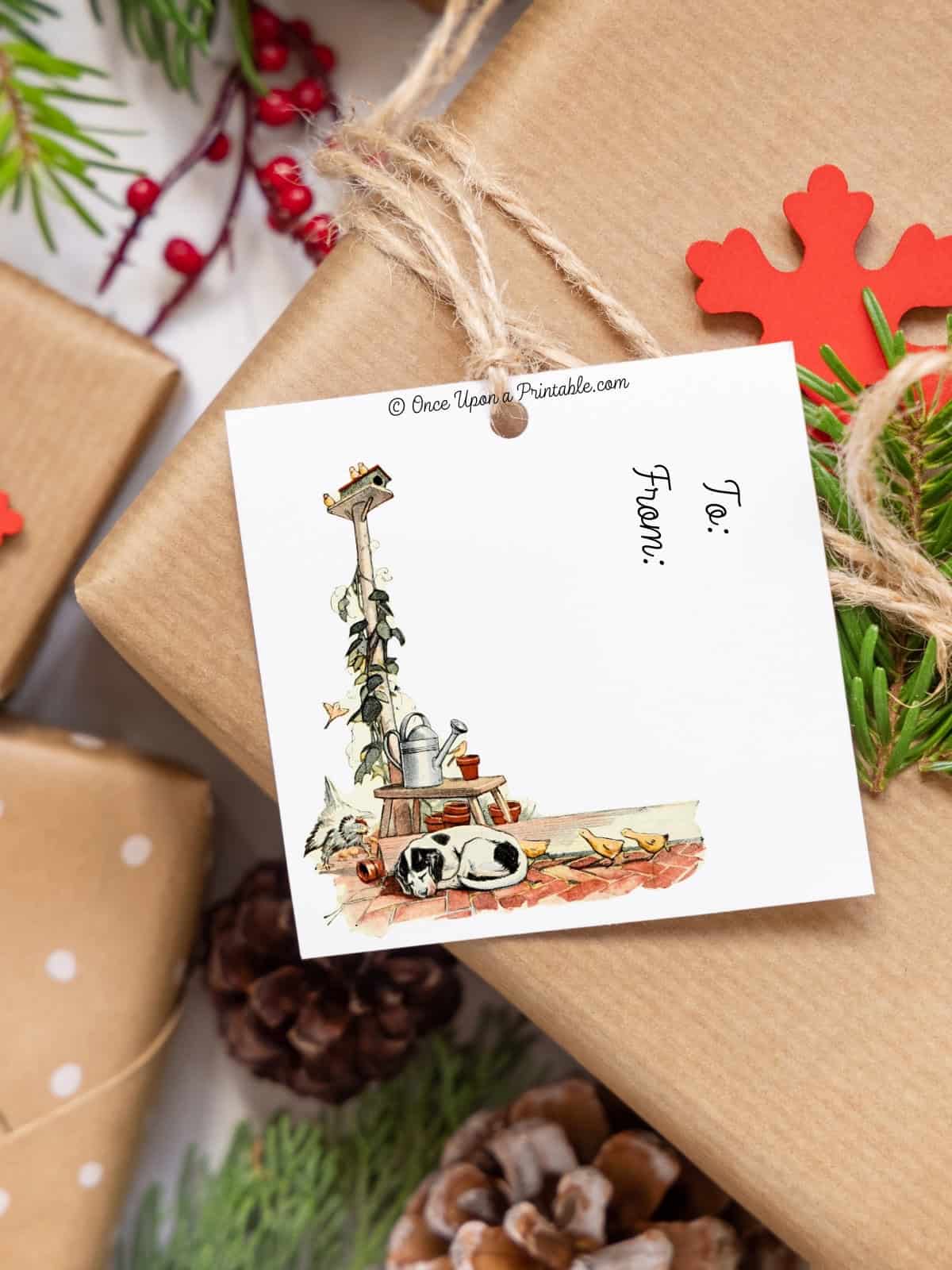 The Little Gingerbread Man illustrated gift tag with beautiful colors a dog sleeping under a bird house, tied onto a brown paper package with twine.