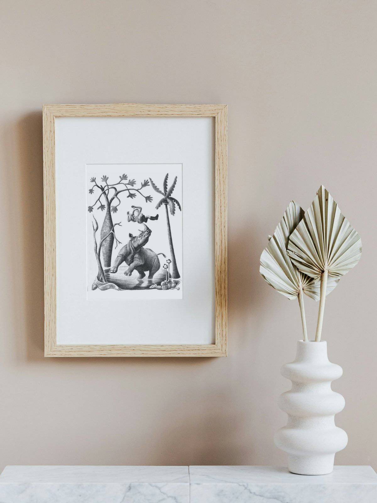 A black and white lithograph framed showing a little boy being thrown by a rhinosaurus.