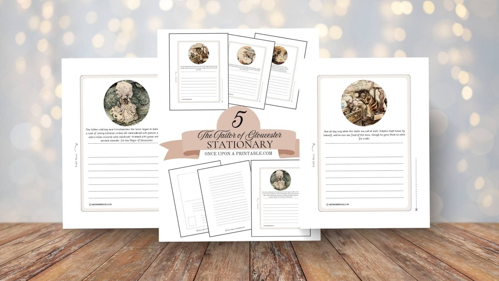 Print outs of two of the stationary with illustrations by Beatrix Potter from the Tailor of Gloucester displayed on a wooden table.