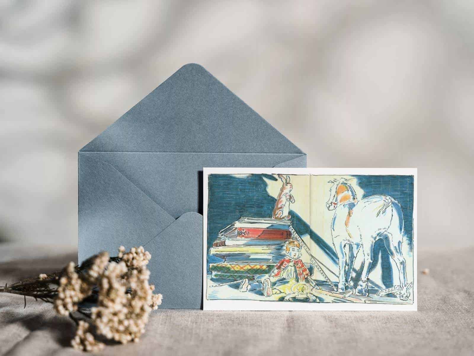 An original illustration of the Velveteen Rabbit talking to the Skin Horse on a note card, with a blue envelope displayed next to dried flowers. 