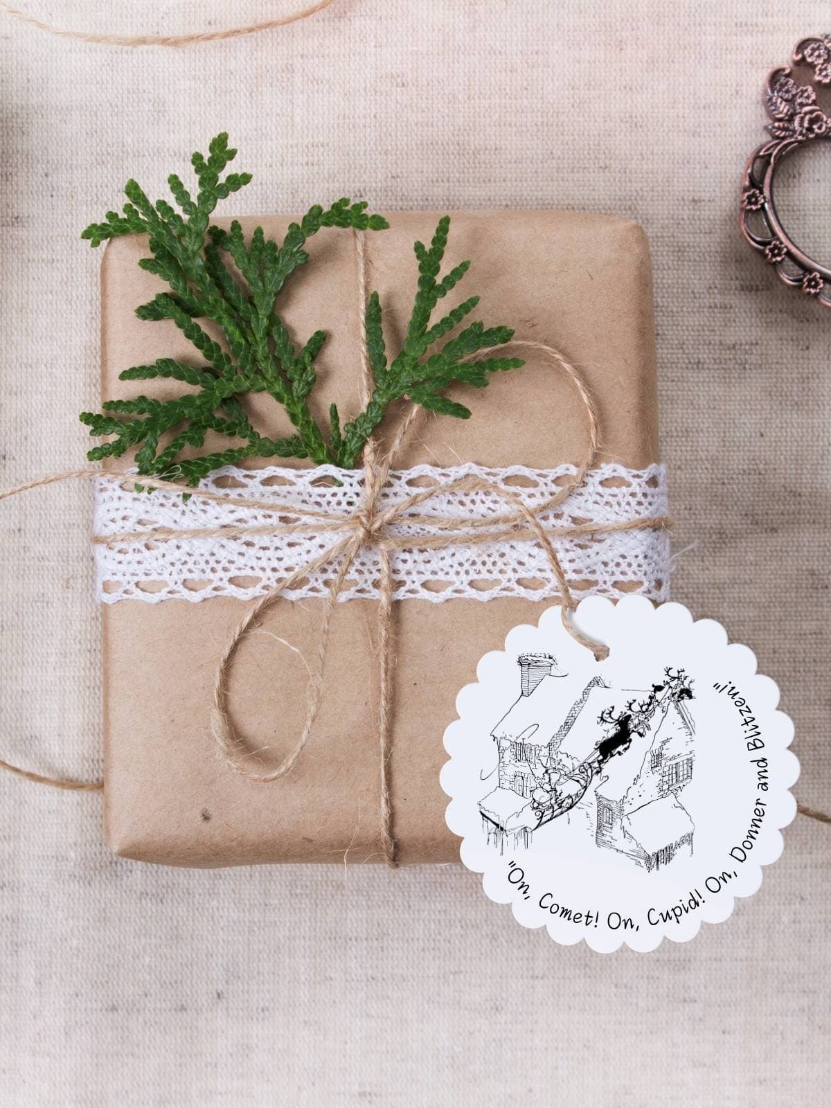 'Twas the Night Before Christmas black and white illustrated christmas gift tag on a brown paper wrapped gift.