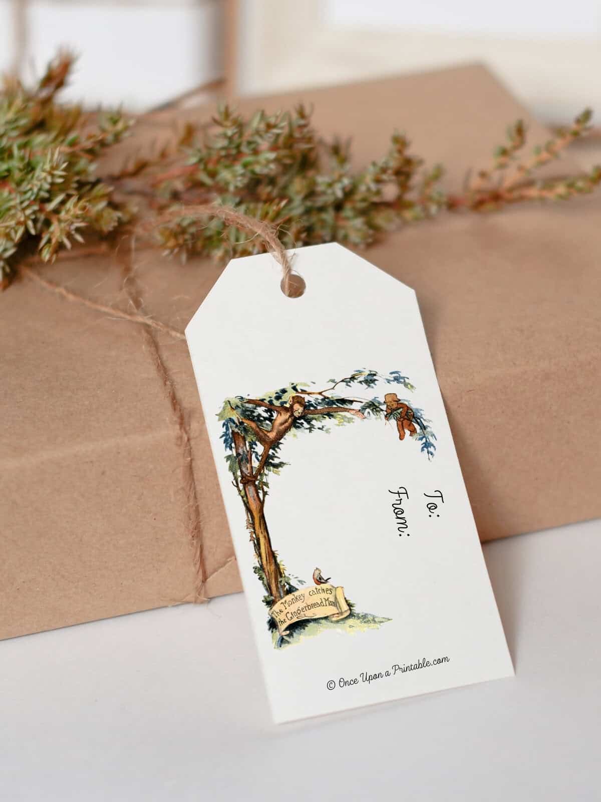 Vintage illustrated gift tags with The little Gingerbread man, tied to a brown paper package with twine.