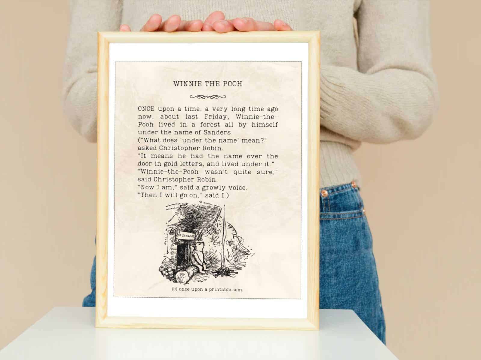 Winnie the Pooh quote framed and held in the hands of a woman.