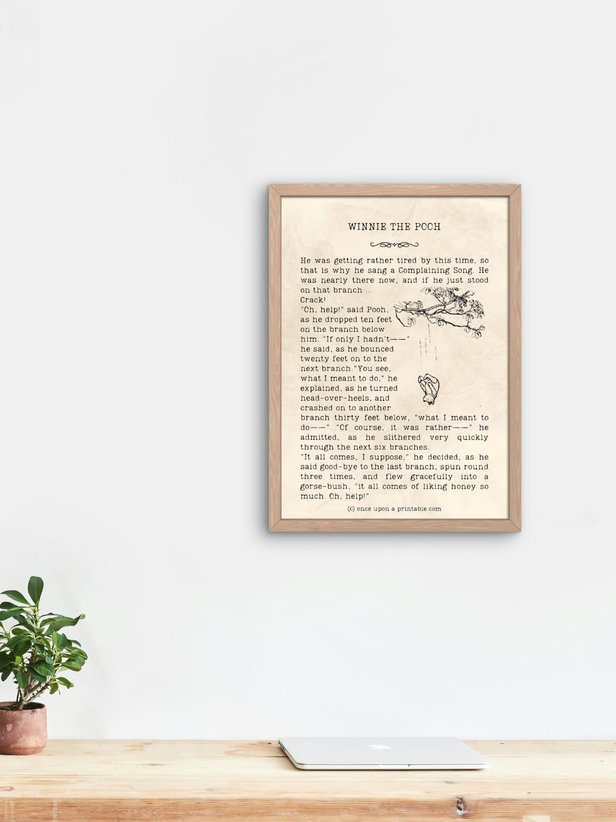 Winnie the Pooh quote framed and displayed above a wooden desk.