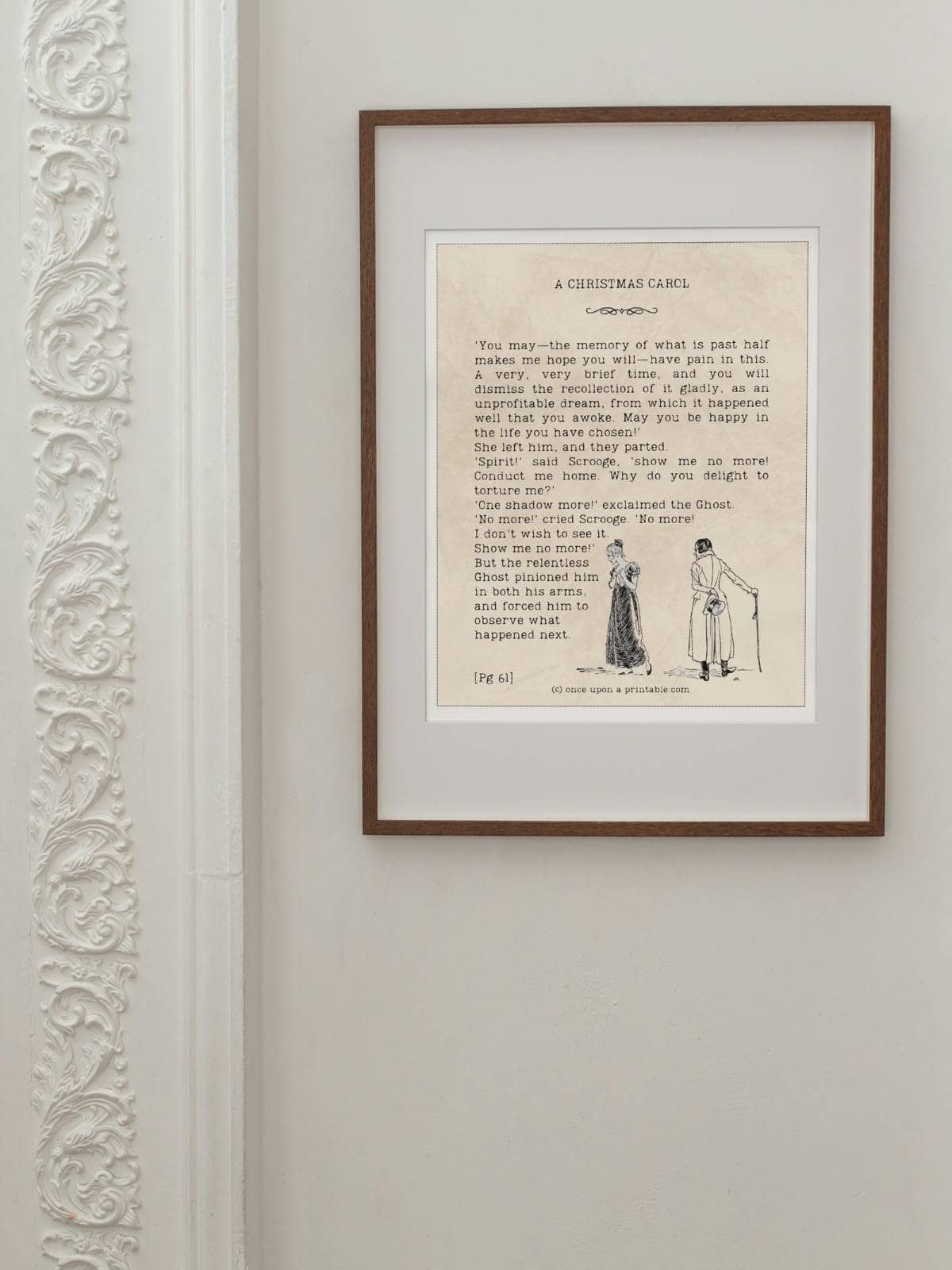 A christmas carol quote in a frame.