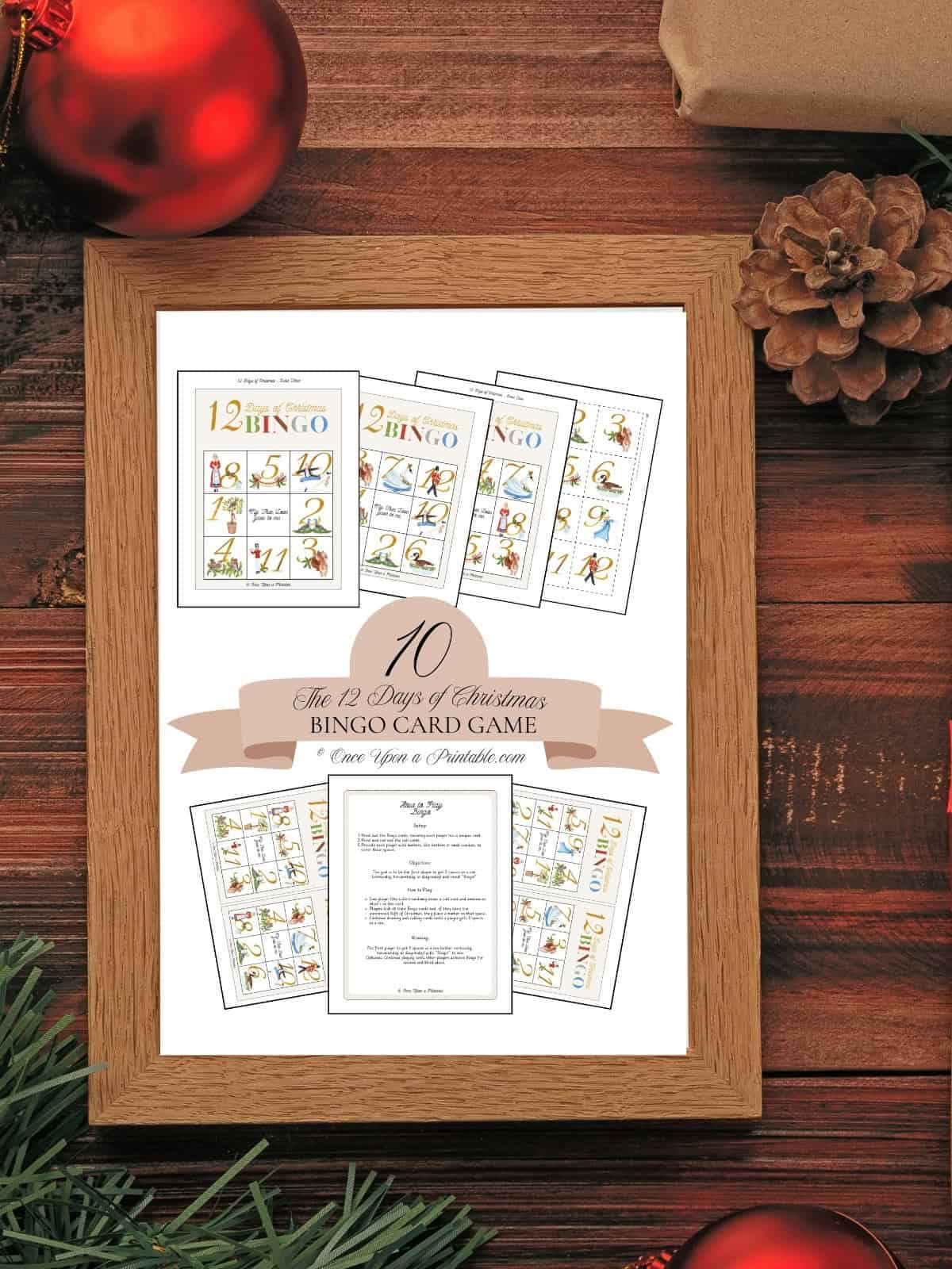 12 Days of Bingo Christmas game card cover page framed and sitting on a wooden floor.