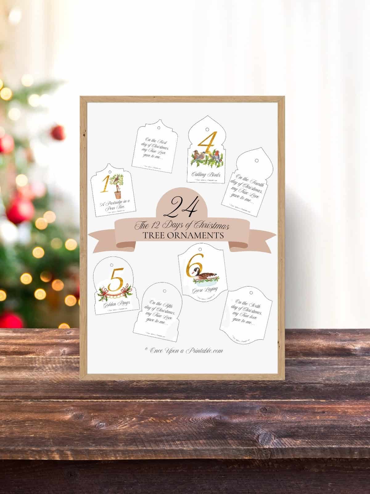 12 Days of Christmas tree ornaments, classic watercolors framed and displayed on a wooden surface with a Christmas tree in the background.