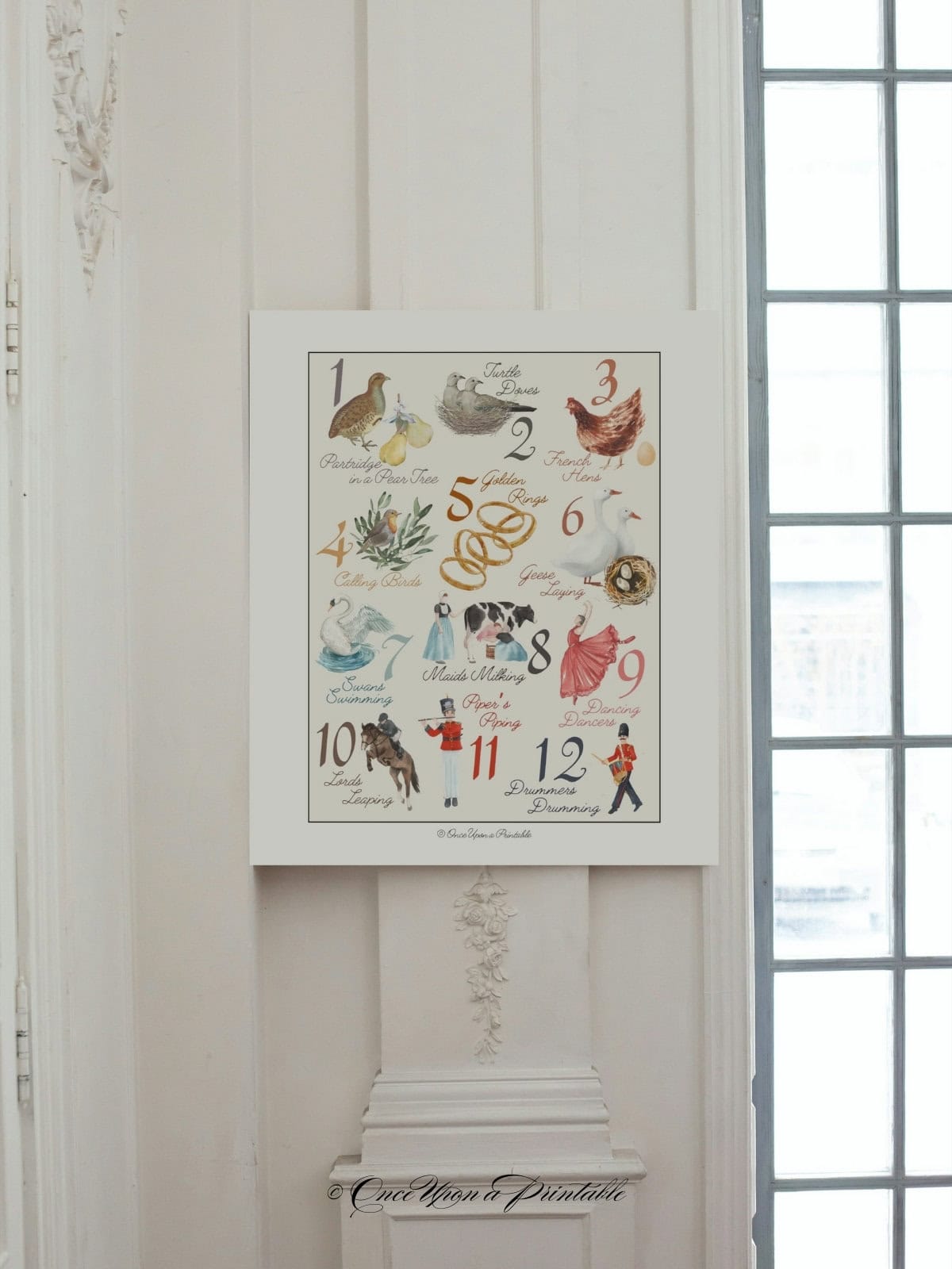 Beautiful and classic watercolor graphic art print of the 12 days of christmas hanging on a wall.