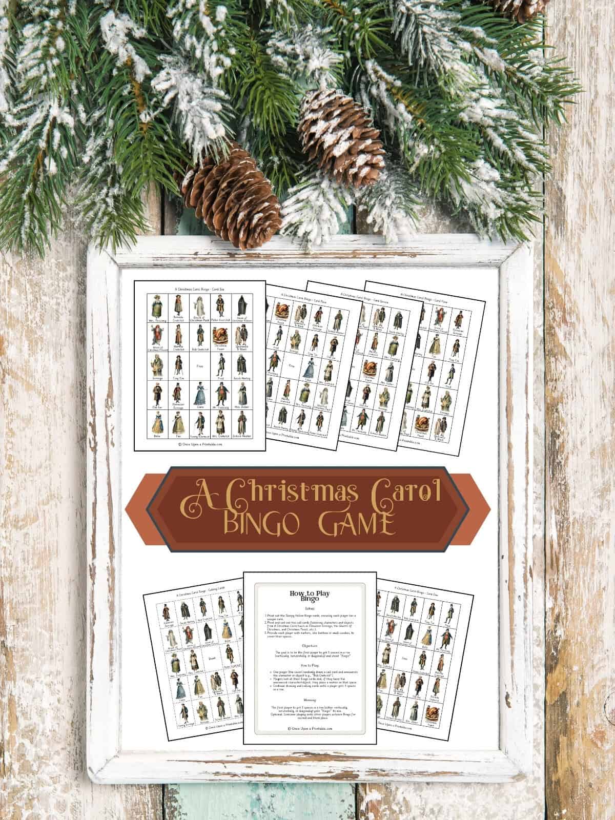 A Christmas Carol inspired bingo game card cover page framed and displayed on a wooden background with garland. 
