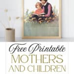 Vintage art print of a mother and daughter reading in a flower field, framed and displayed next to a vase with dried flowers in it.