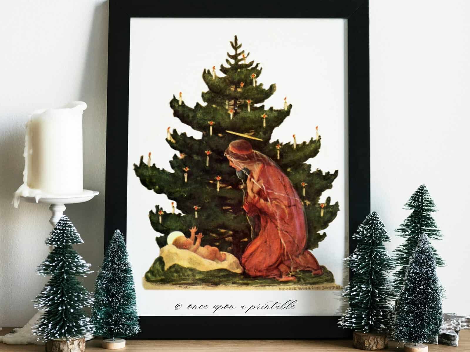 Vintage illustration of Mary and baby Jesus in front of a christmas tree framed and displayed by fame bottlebrush trees and a candle.