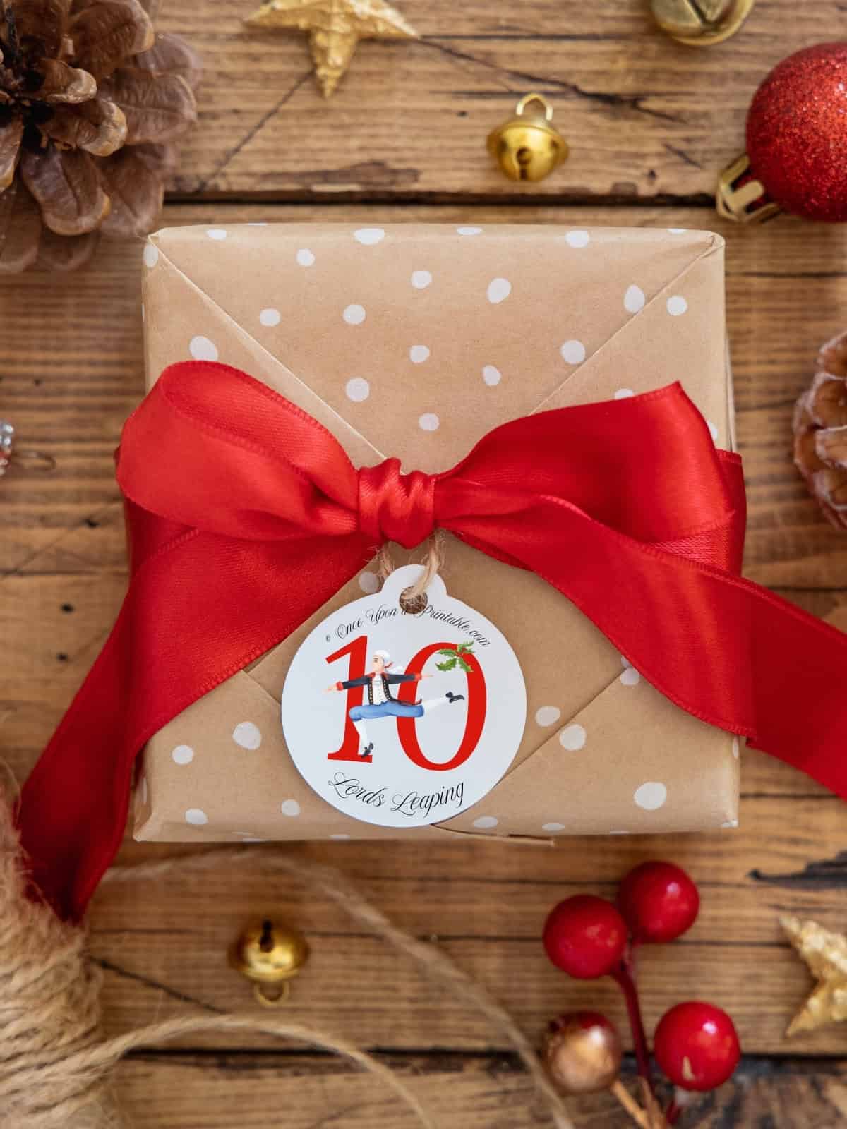 Ten Lords Leaping watercolor gift tag on a Christmas present.