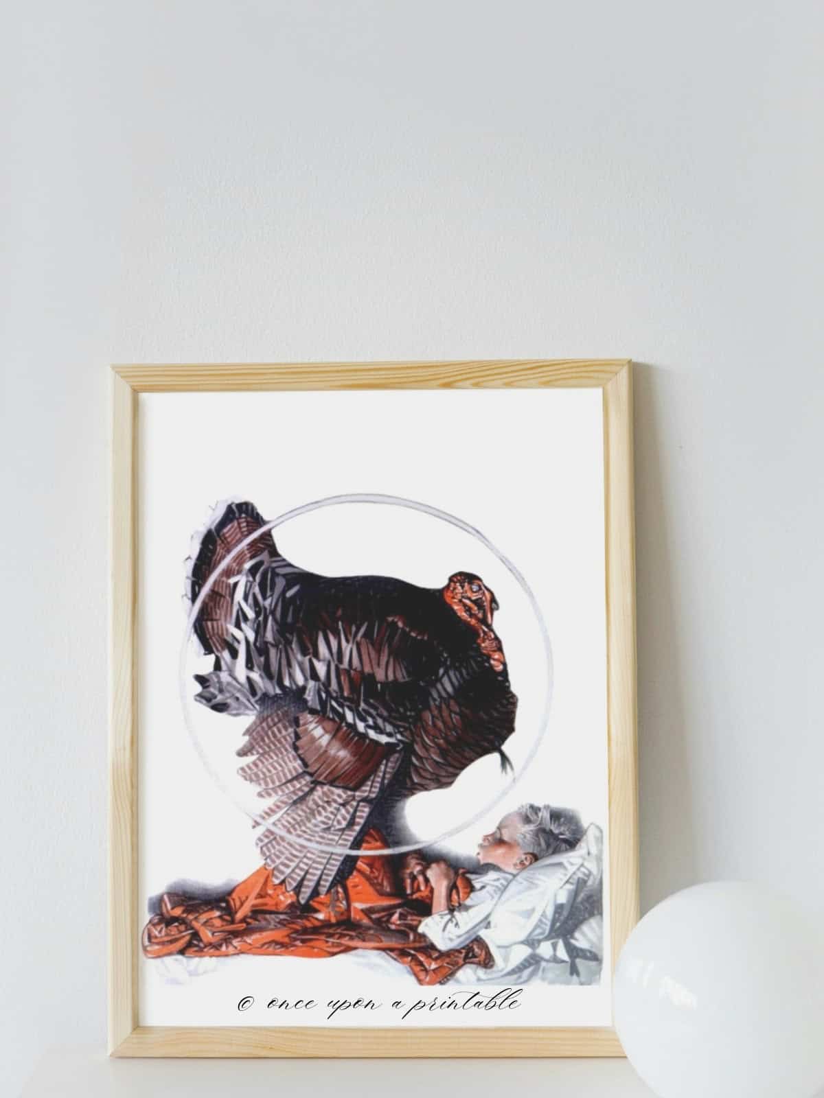 J. C. Leyendecker illustration of a turkey sitting on the stomach of a boy in bed, framed and displayed.