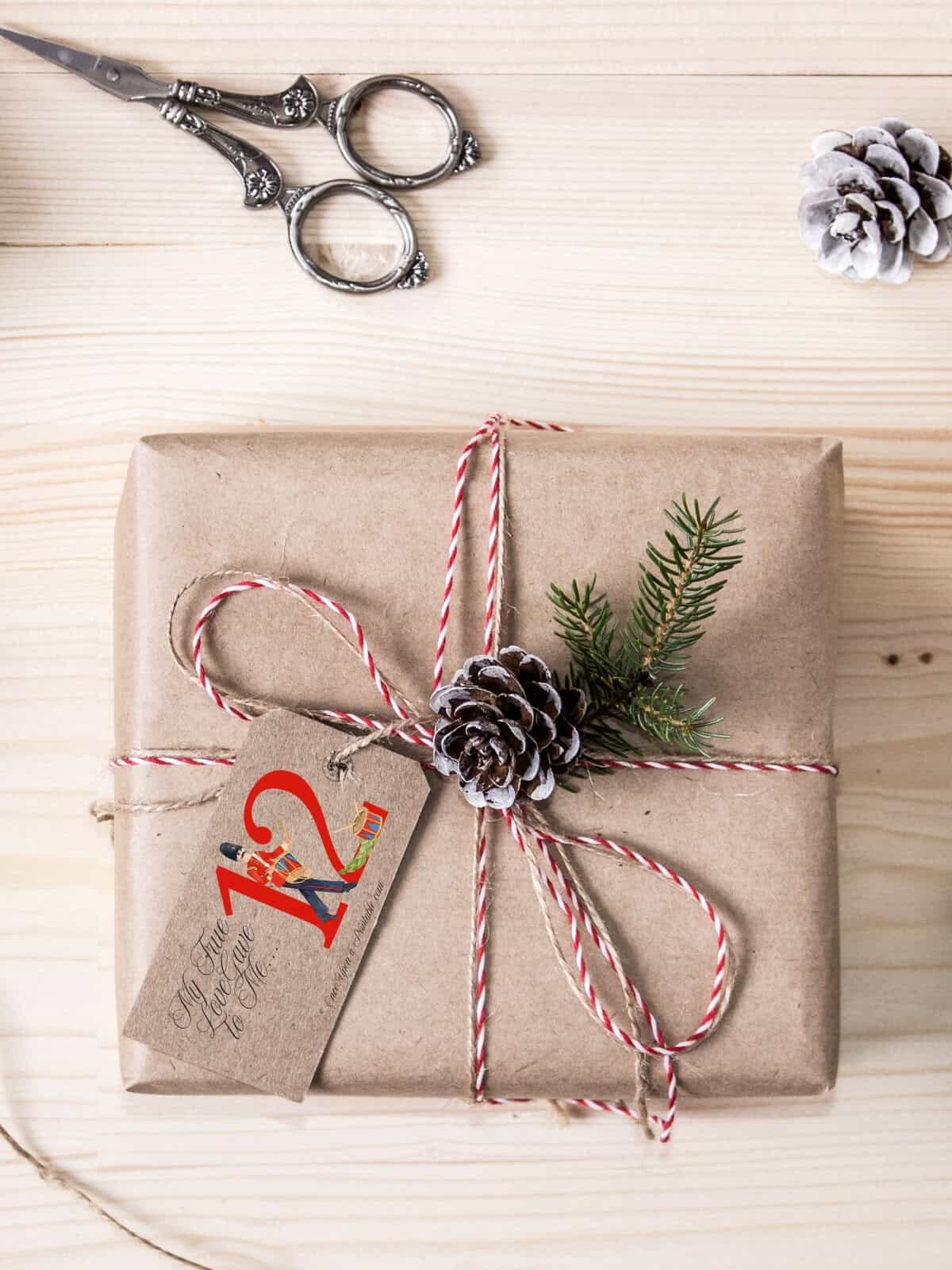 Twelve Drummer's Drumming gift tag on a wrapped christmas present.