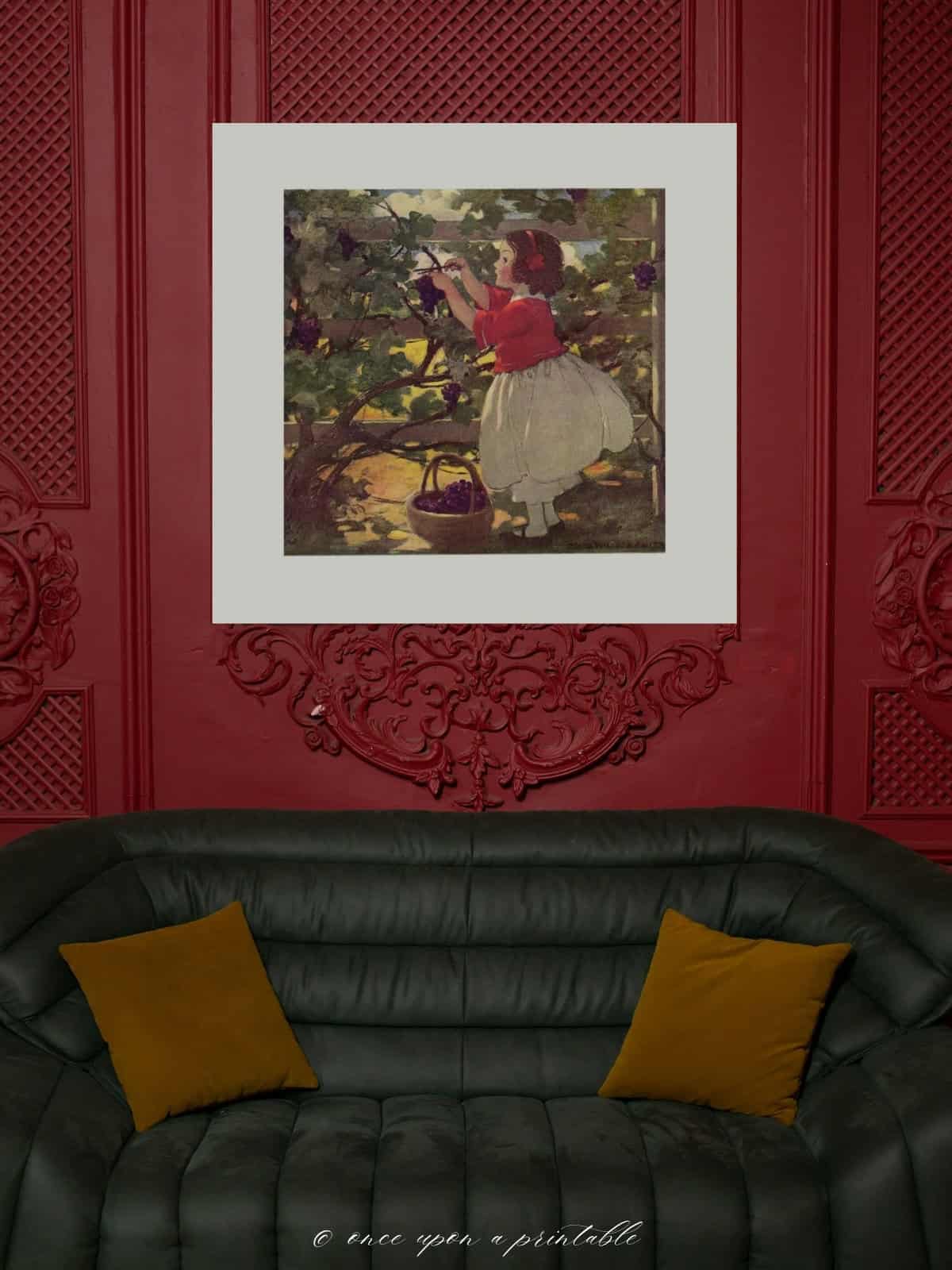 A child picking berries, a vintage illustration framed and displayed on a dark burgundy wall above a black leather couch.