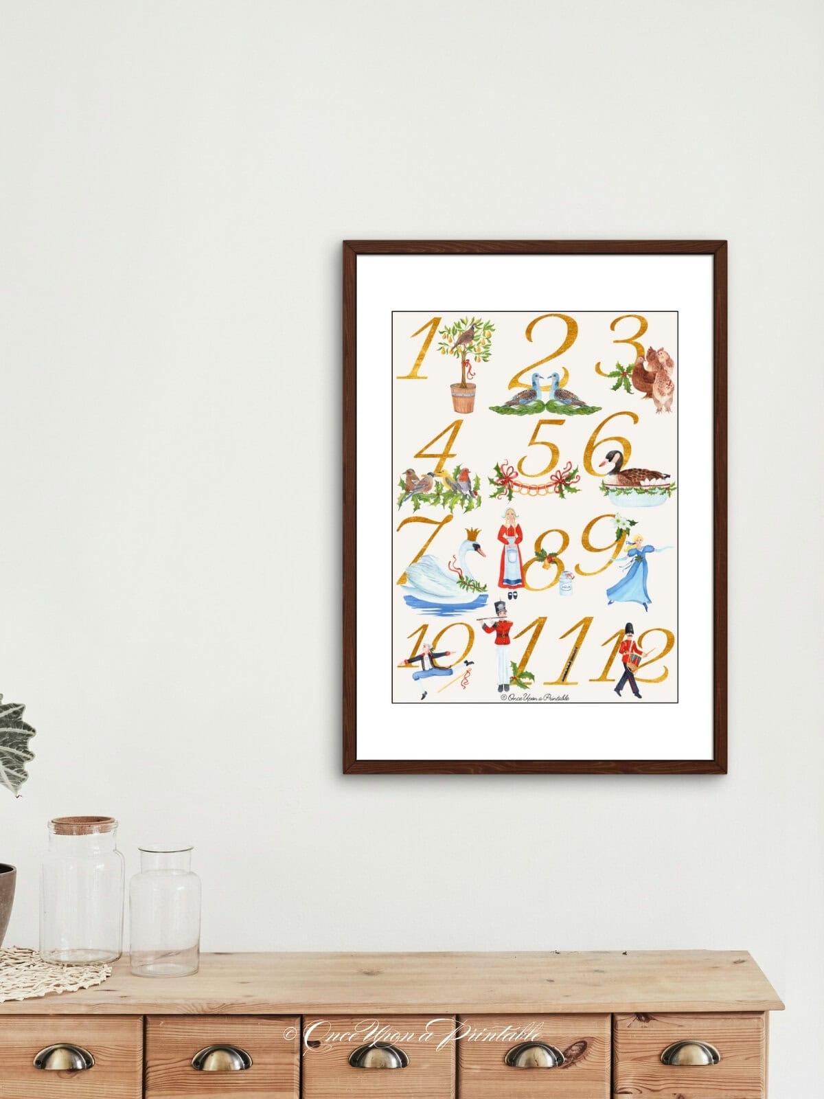 Classic watercolor framed wall art on a wooden dresser. 