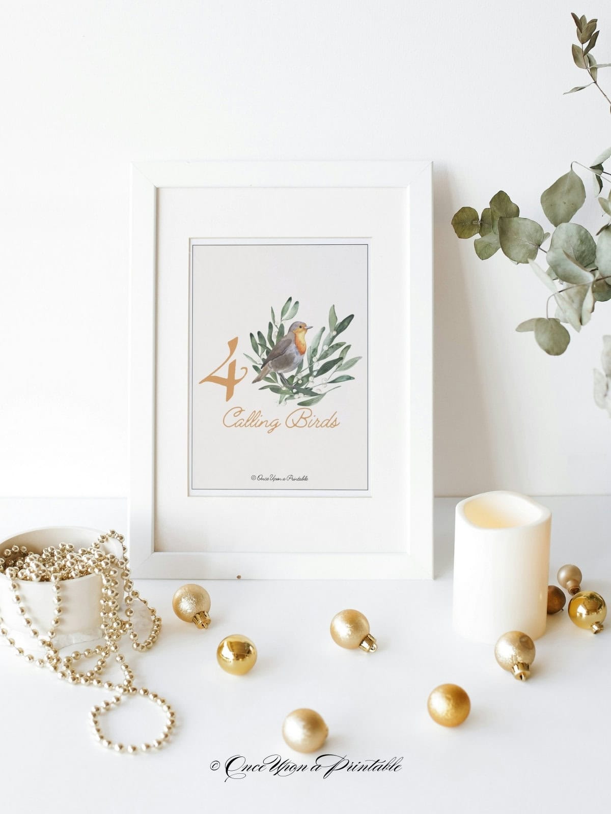 Four calling birds watercolor art print in a frame displayed with baubles.