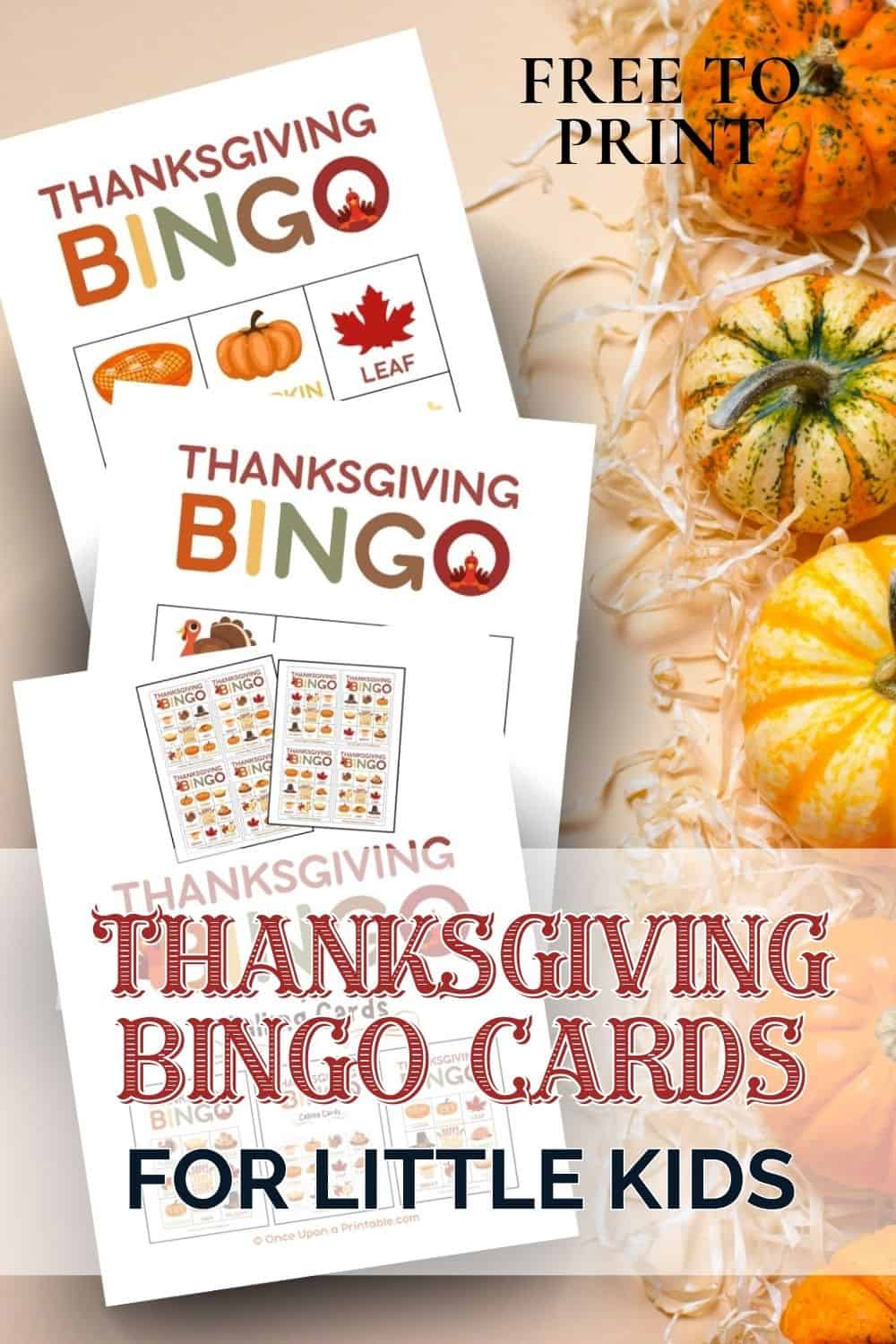 Thanksgiving Bingo cards laying on a peach background with hay and pumpkins.